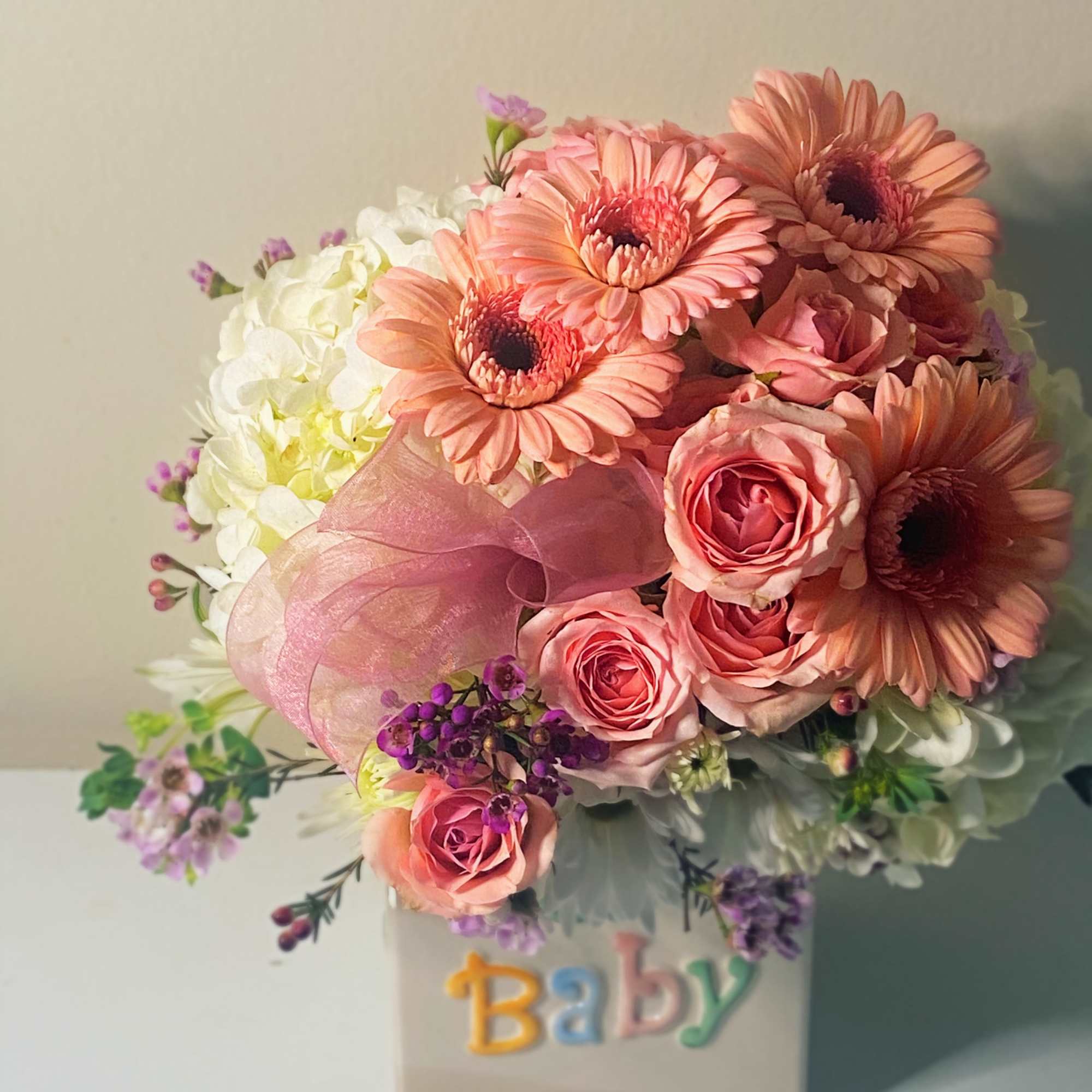 Baby girl is a sweet collection of white hydrangea, pink gerber daisies