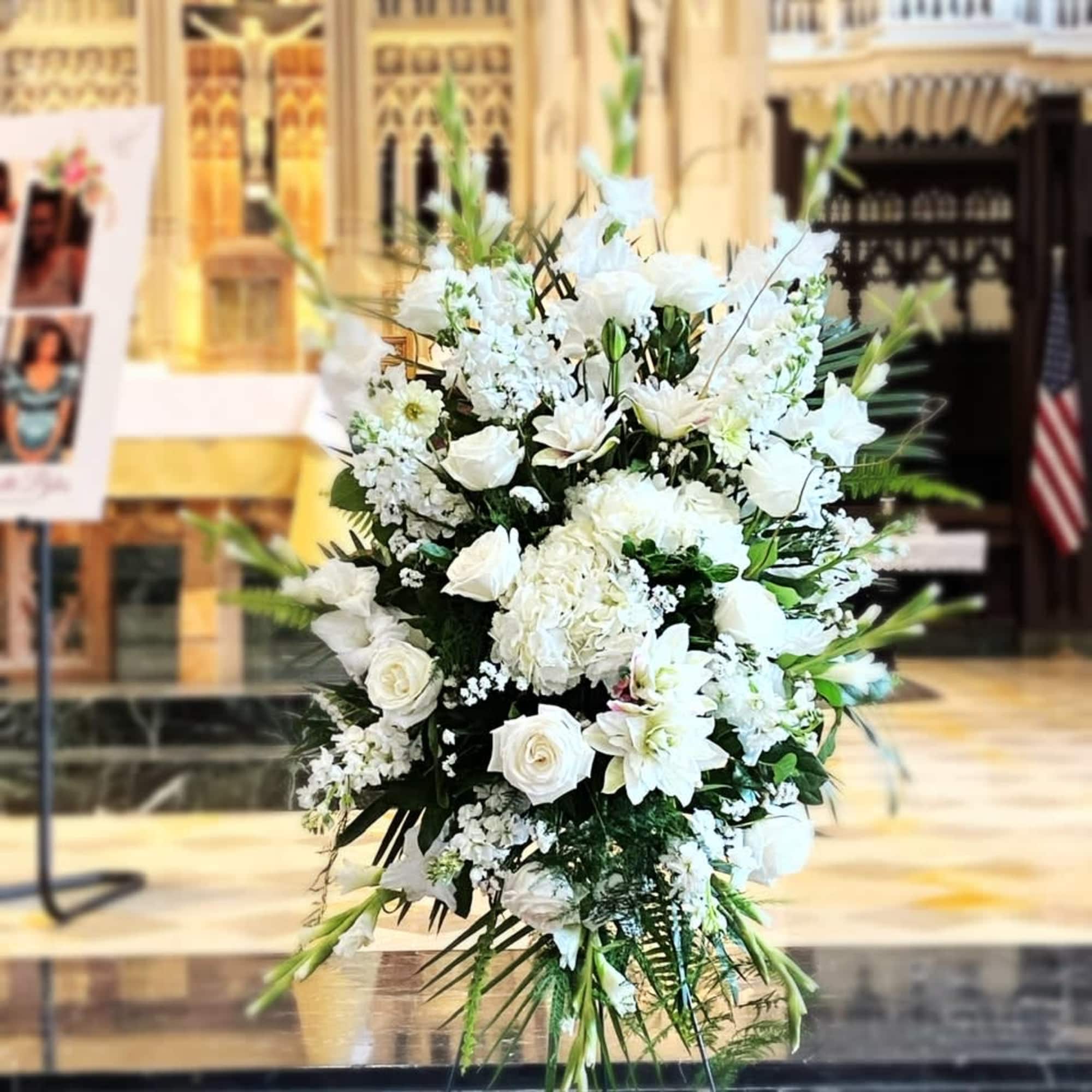 White Bliss Standing funeral spray is a beautiful crisp white elegant funeral