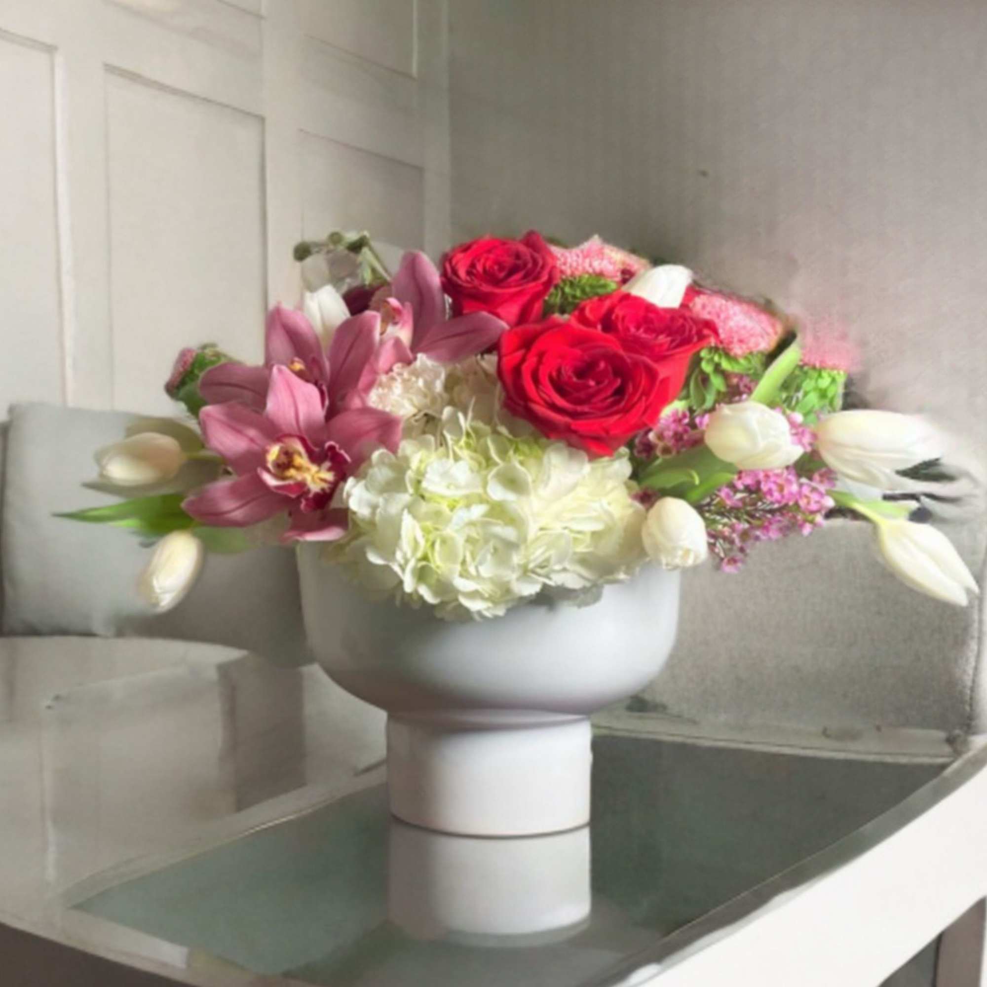 Beautifully stylized Valentines Floral in a modern footed white vase. 