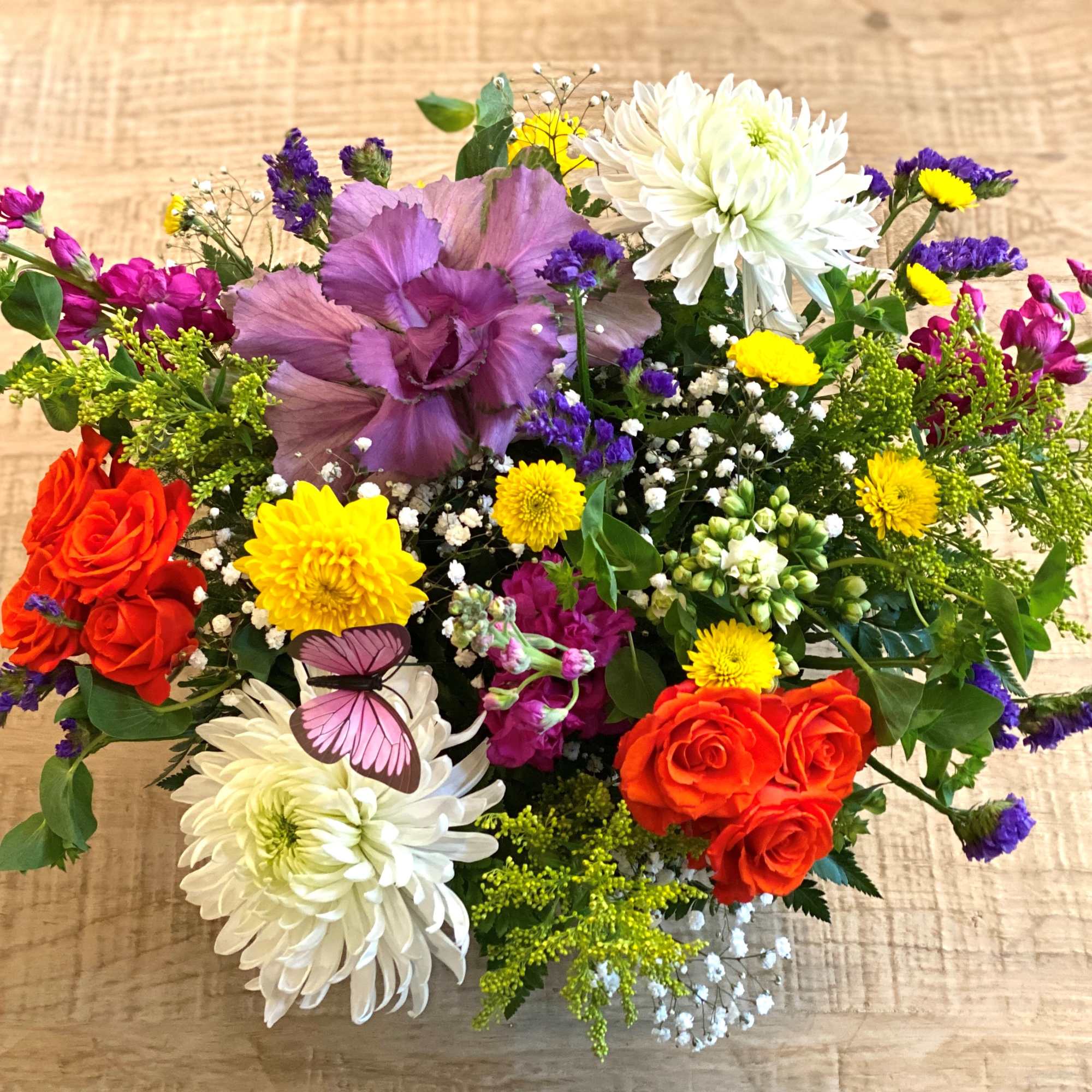 Mixed bouquet with purple, white, yellow, and orange flowers