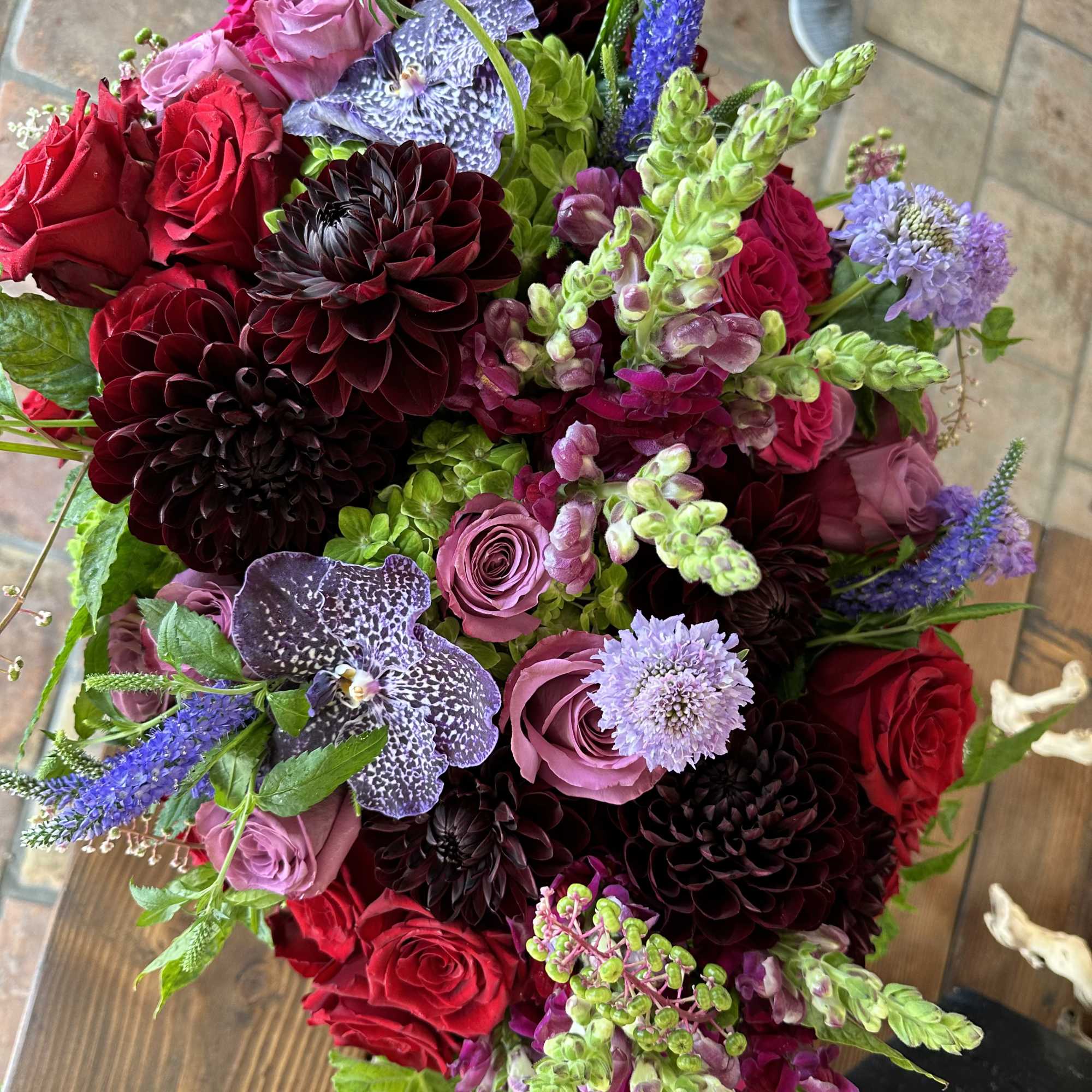 Bouquet of red and pink roses with purple blooms