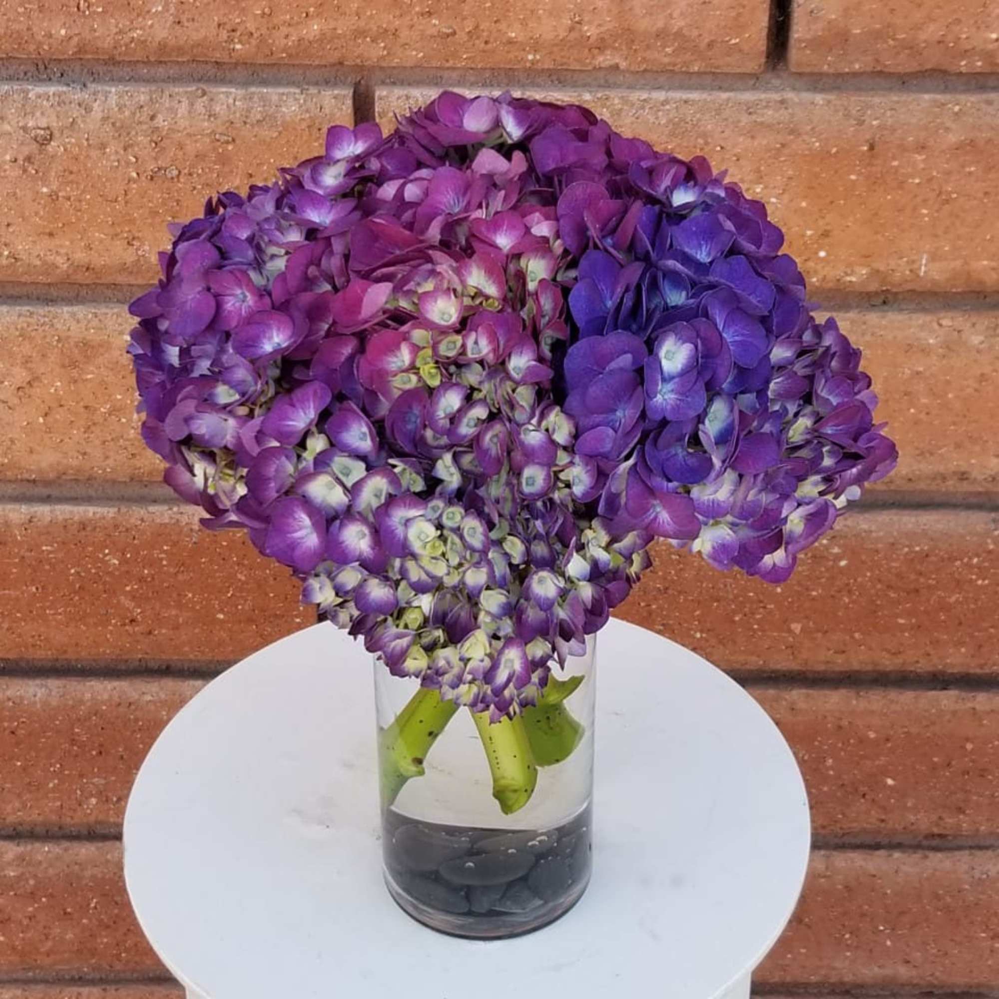 Purple hydrangea bouquet in a clear glass vase
