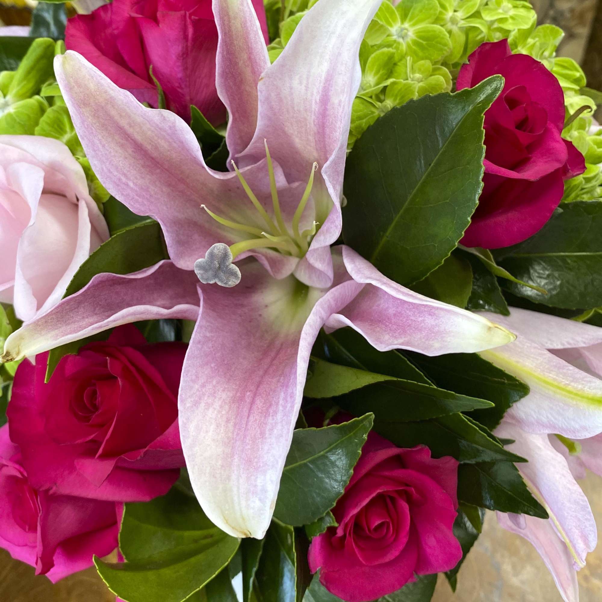 Pink lilies and hot pink roses in a close-up bouquet