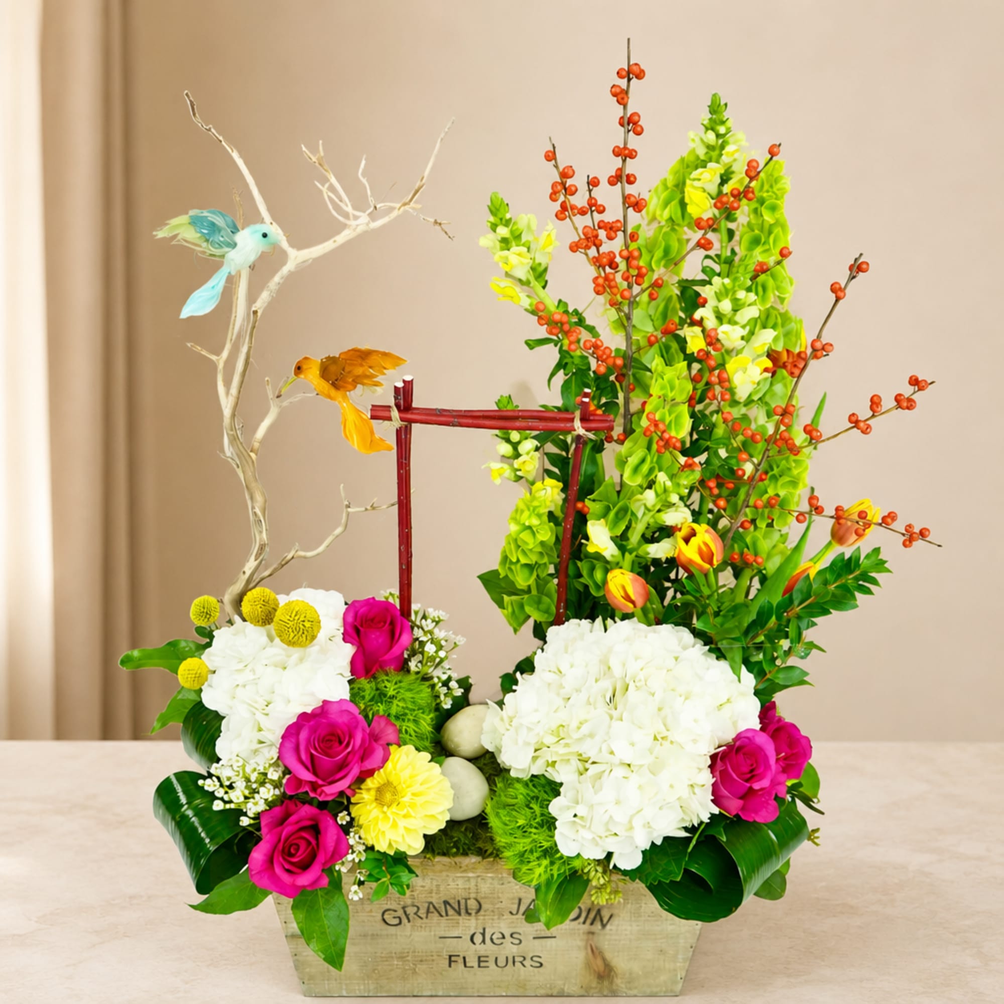 Colorful floral arrangement in a wooden box with birds and branches