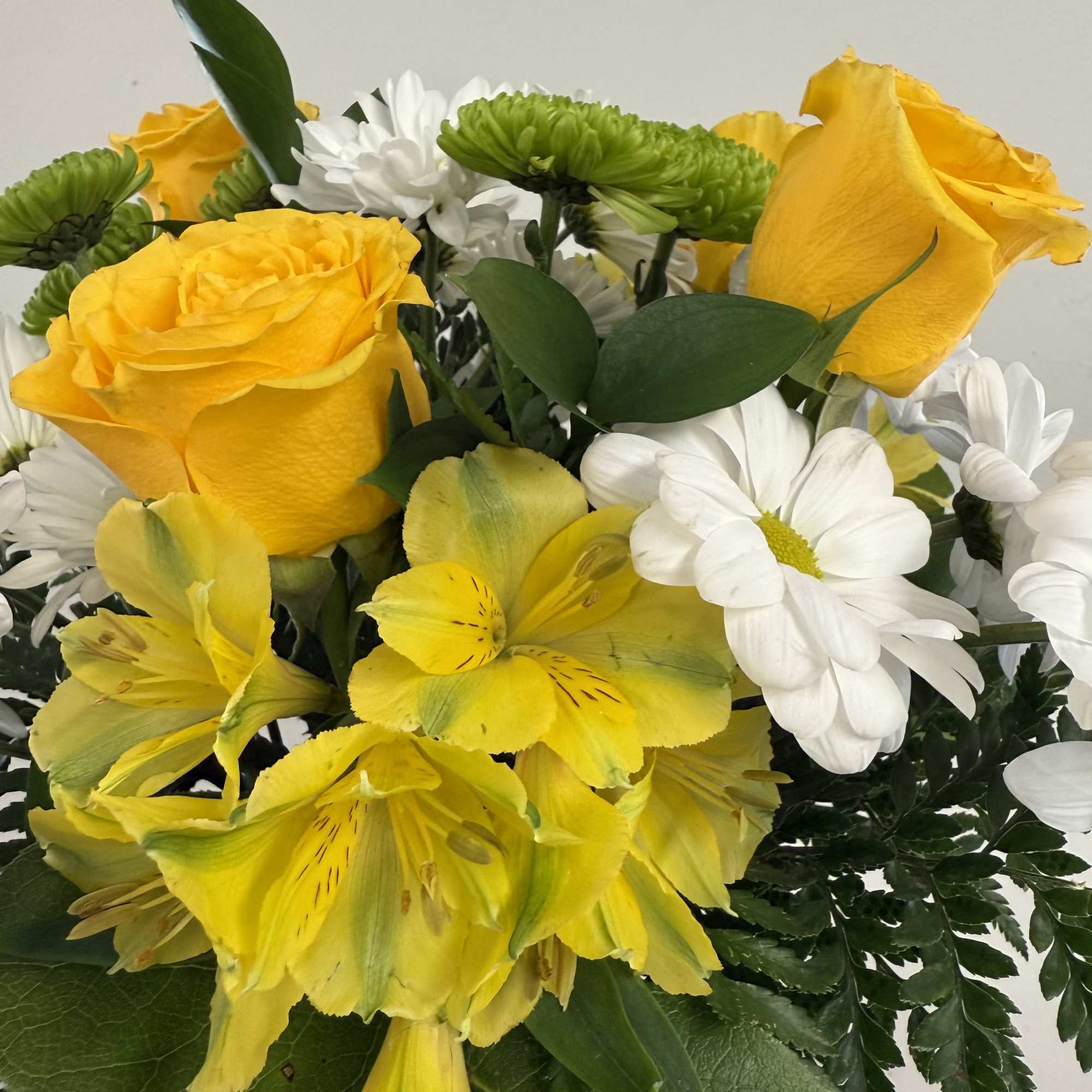 Yellow roses and white daisies with yellow alstroemeria in a bouquet