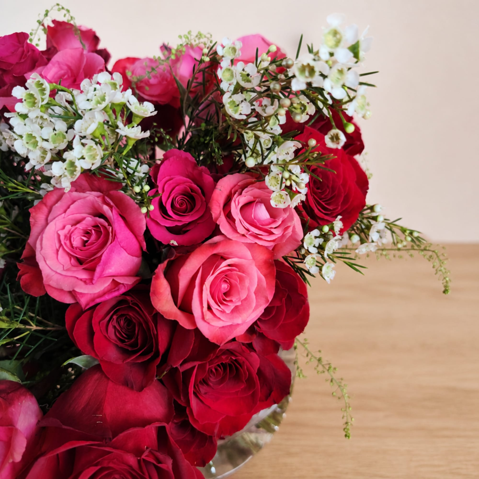 Bouquet of pink and red roses with small white filler flowers, photo 2 of 3