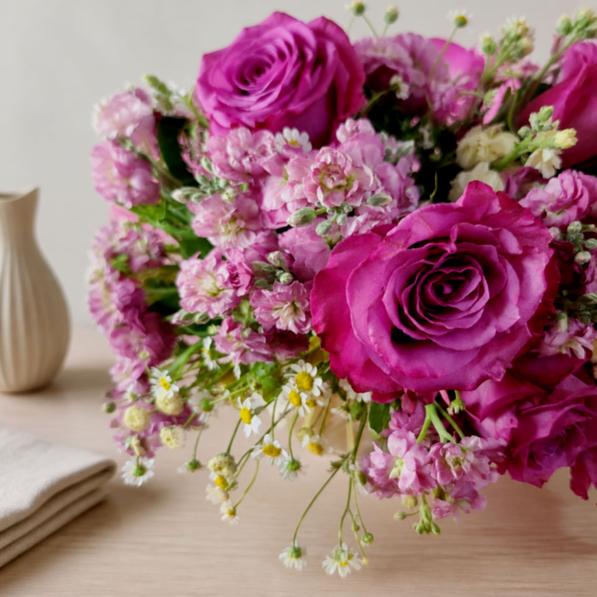 Pink rose bouquet with small pink and white filler flowers