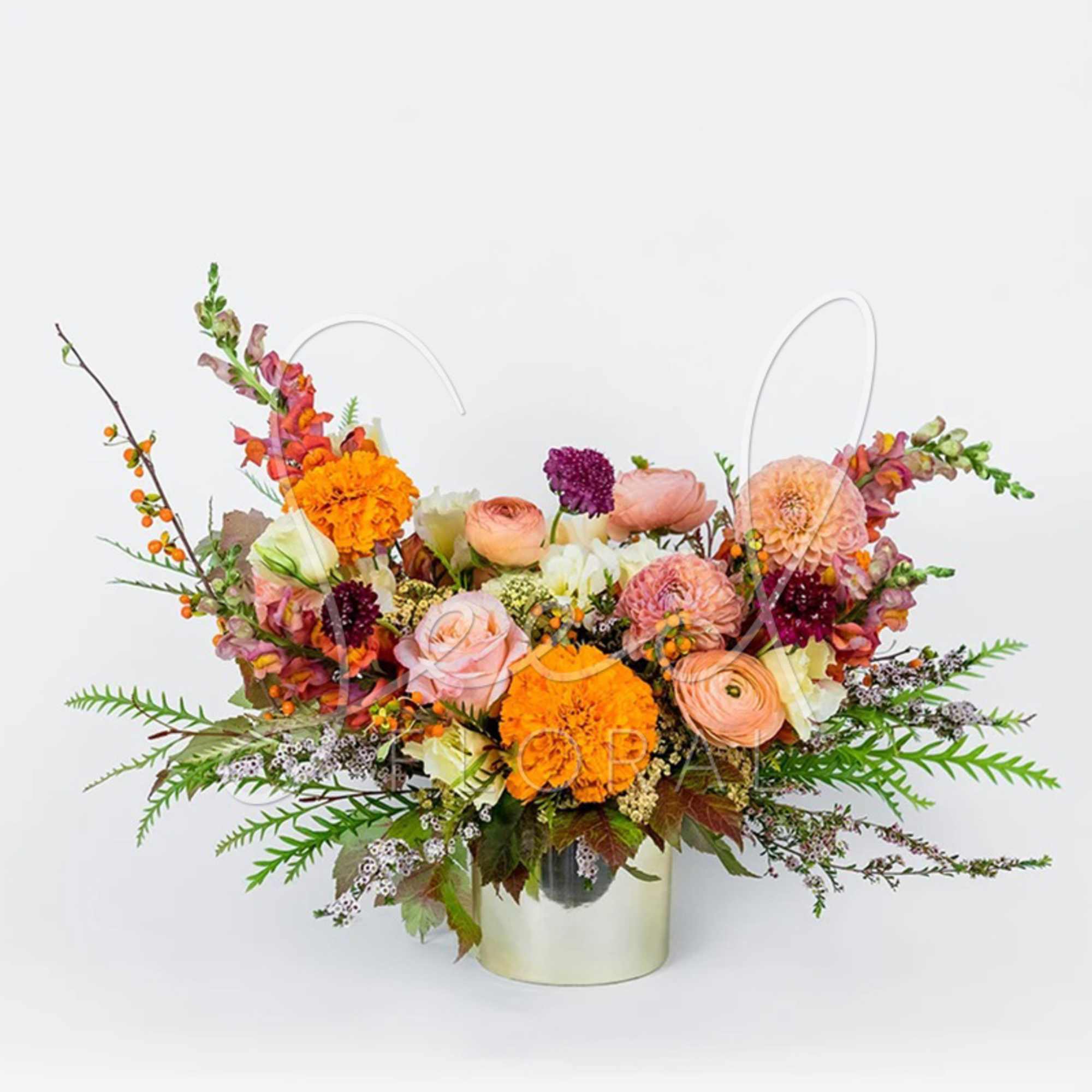 Bring the rich beauty of fall indoors with our Autumn Sunset arrangement.