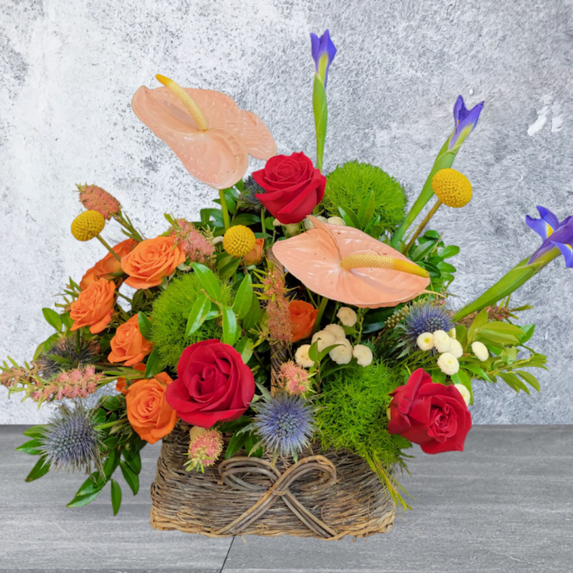Red Roses, Orange garden roses, Anthurium, Iris arrangements in the Basket
