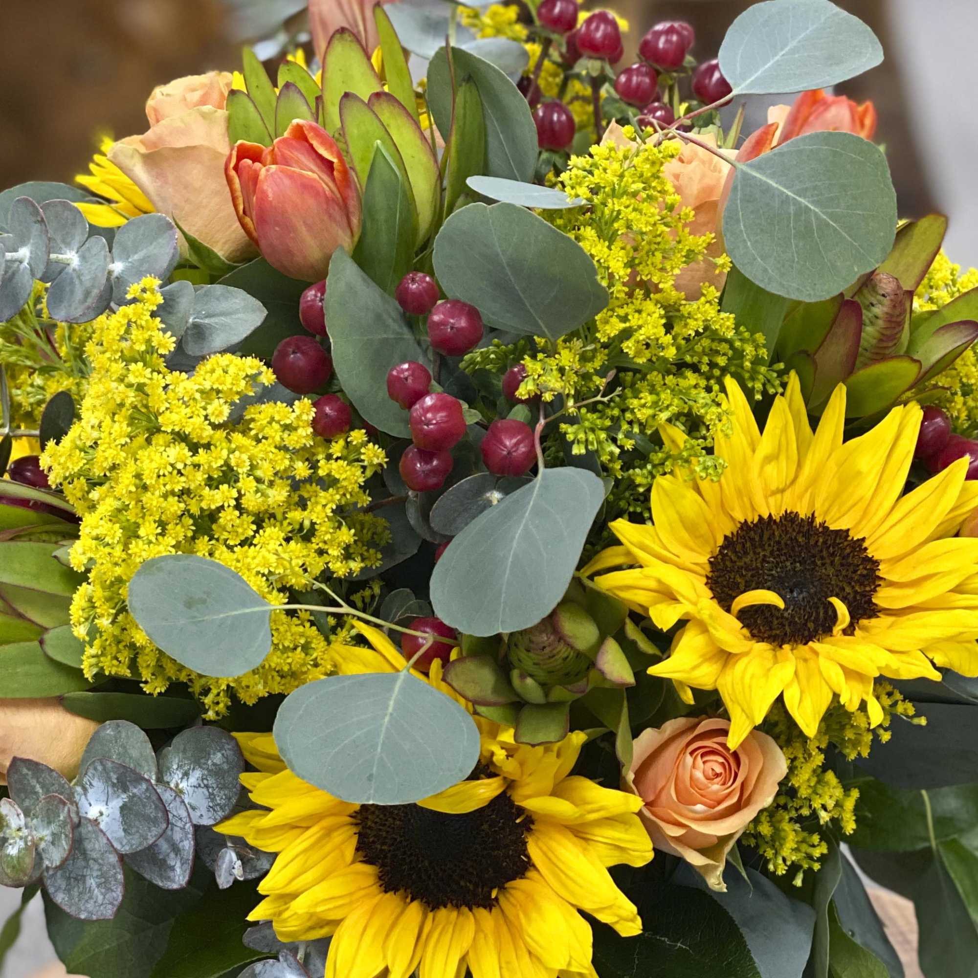 Bouquet with sunflowers, peach roses, and tulips