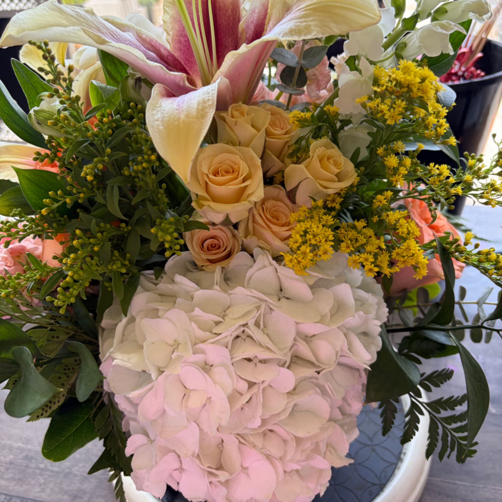 Bouquet with pink lilies, cream roses, and white hydrangea