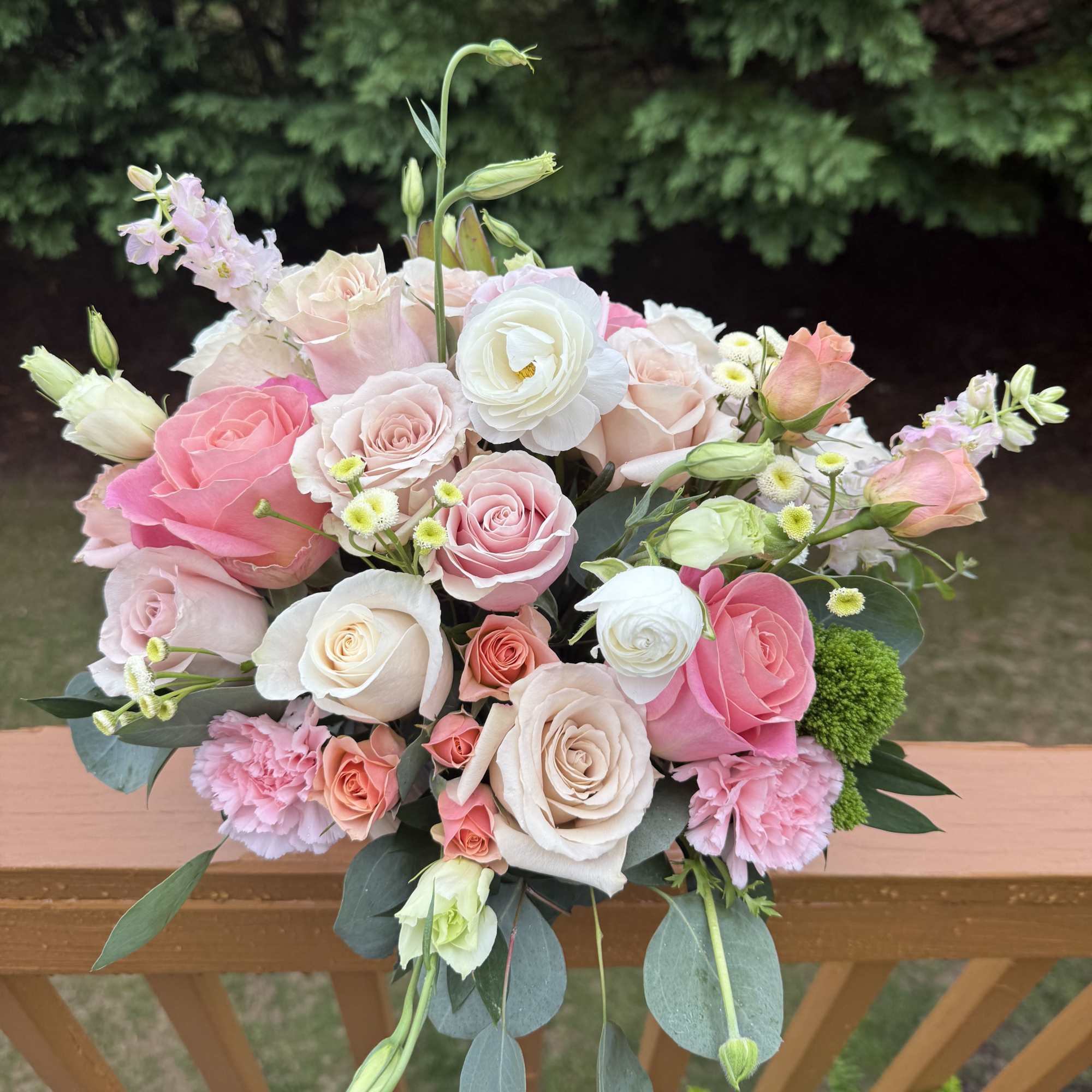 Pastel bouquet of pink and cream roses with white ranunculus and mixed blooms