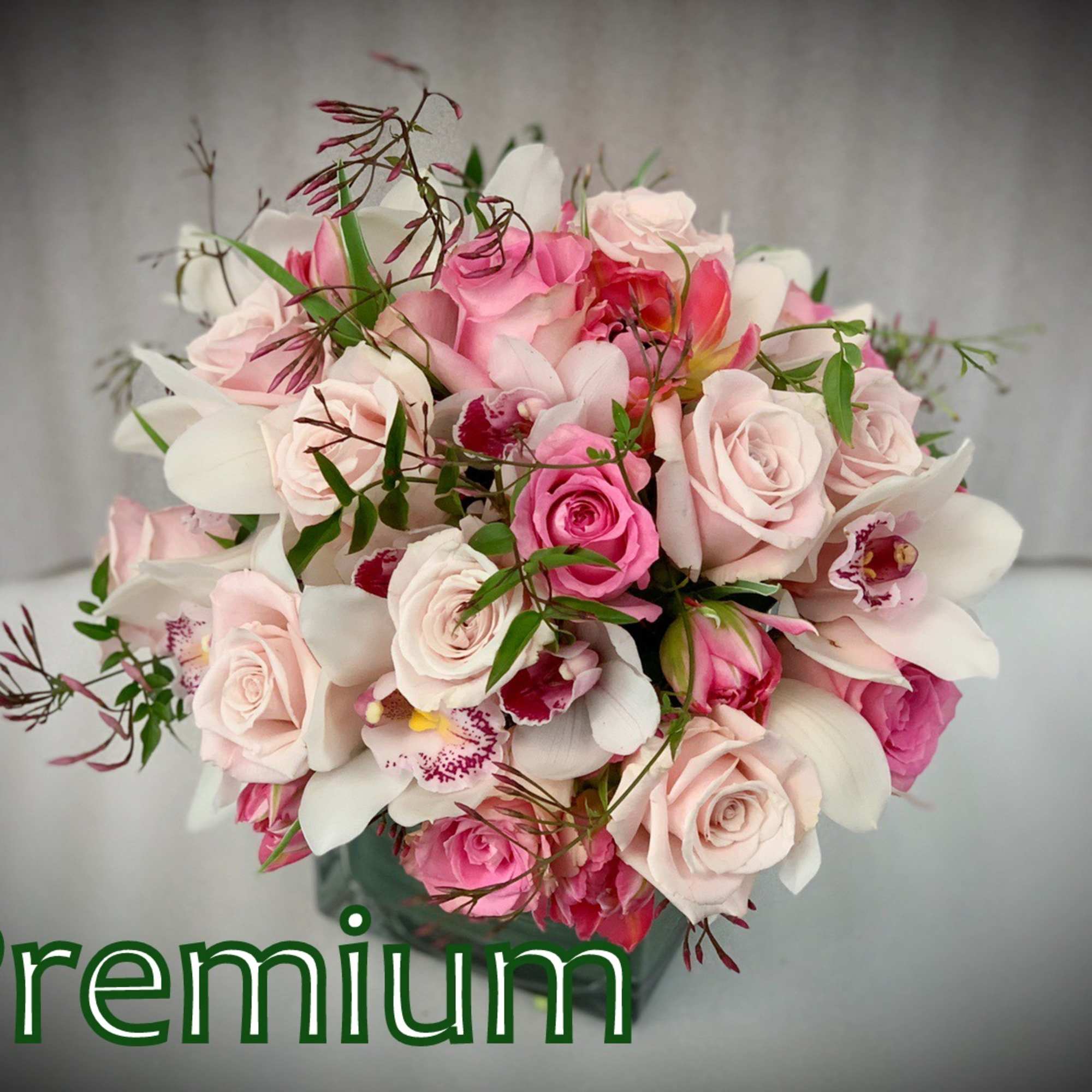 Pink and white bouquet of roses and orchids in a vase
