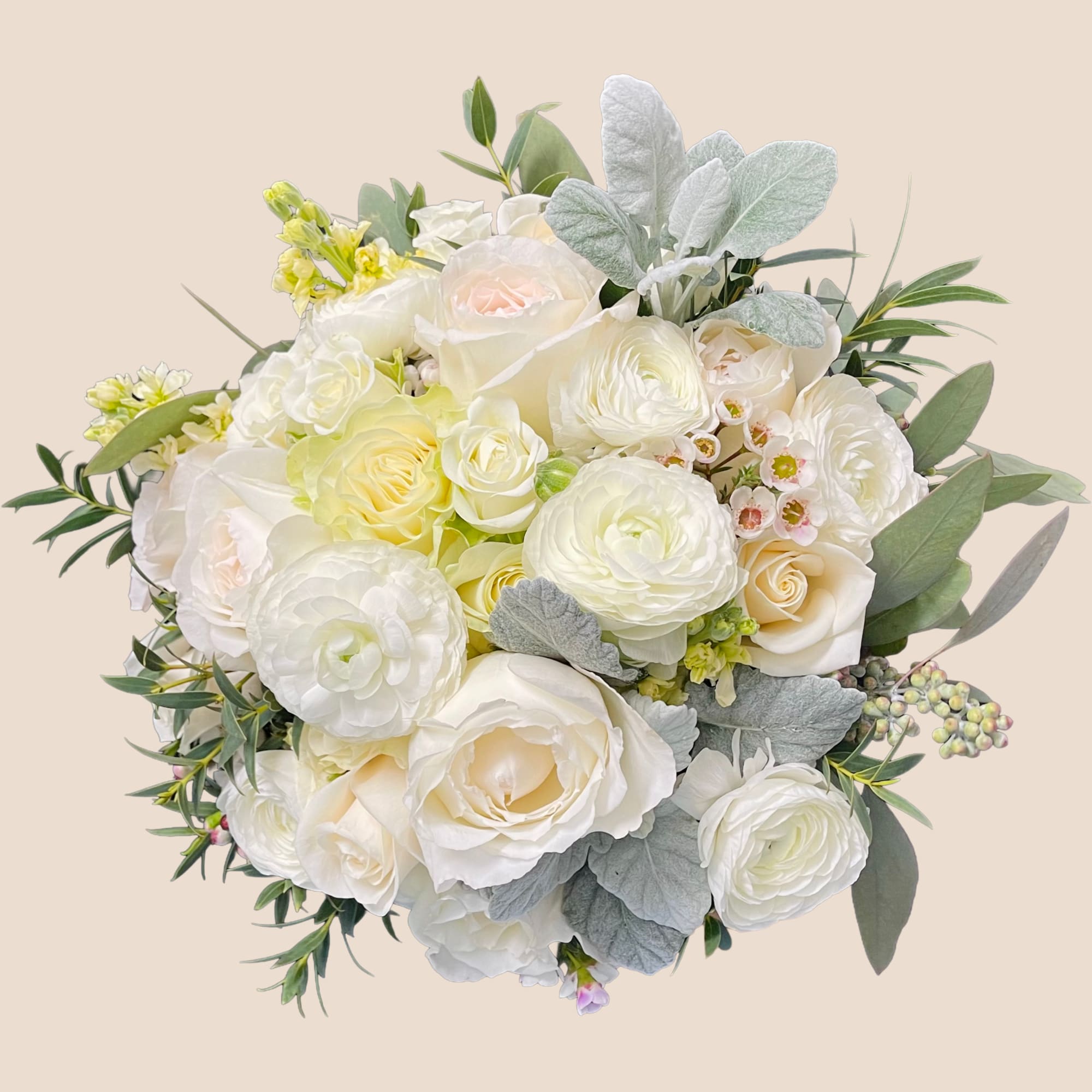 Cream and white bouquet of roses and ranunculus with soft greenery