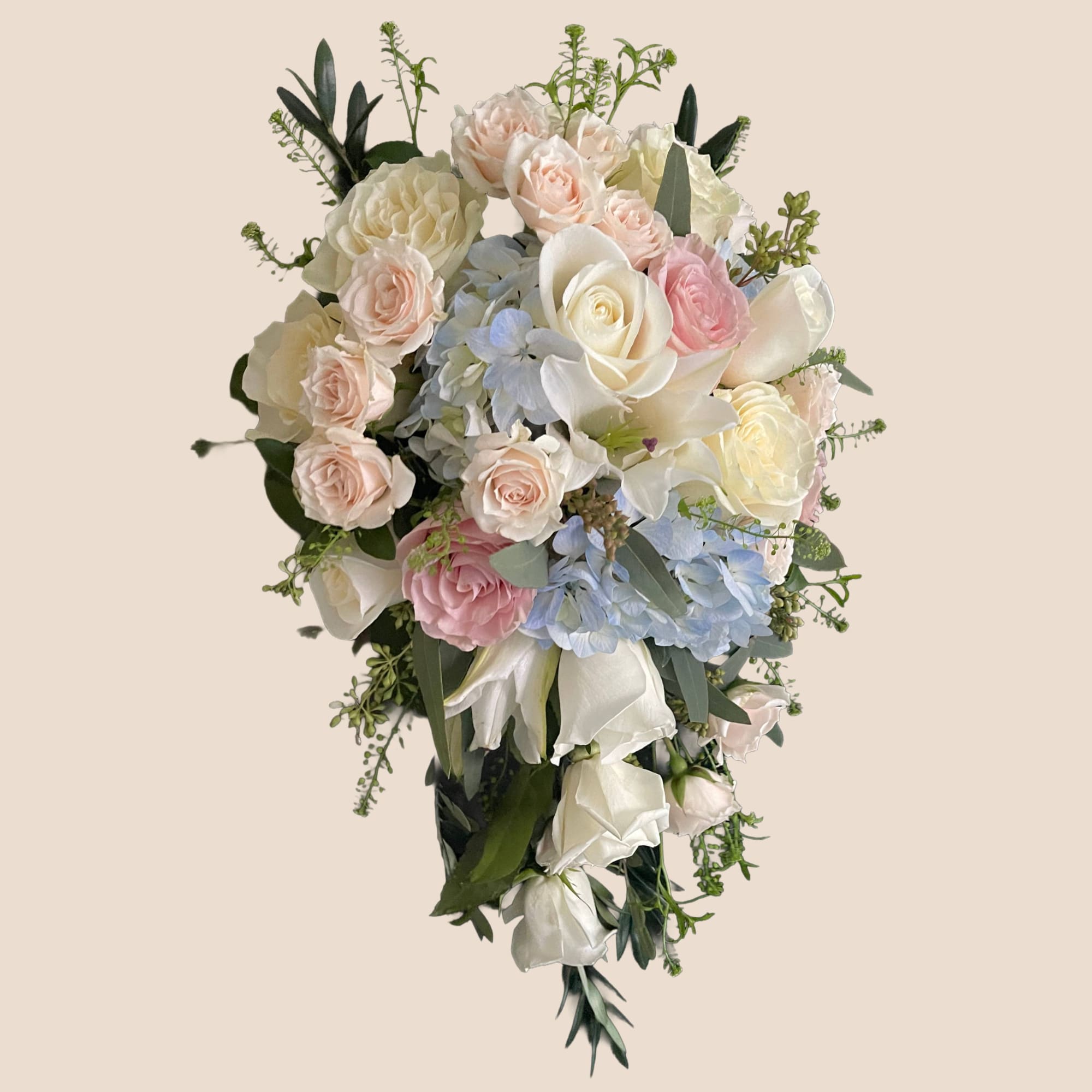 Cascade bouquet of pastel roses, hydrangeas, and white calla lilies