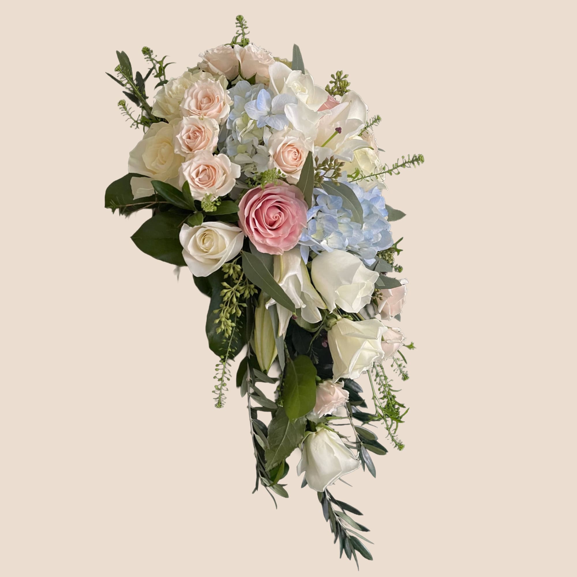 Cascade bouquet of white, blush, and blue flowers with trailing greenery