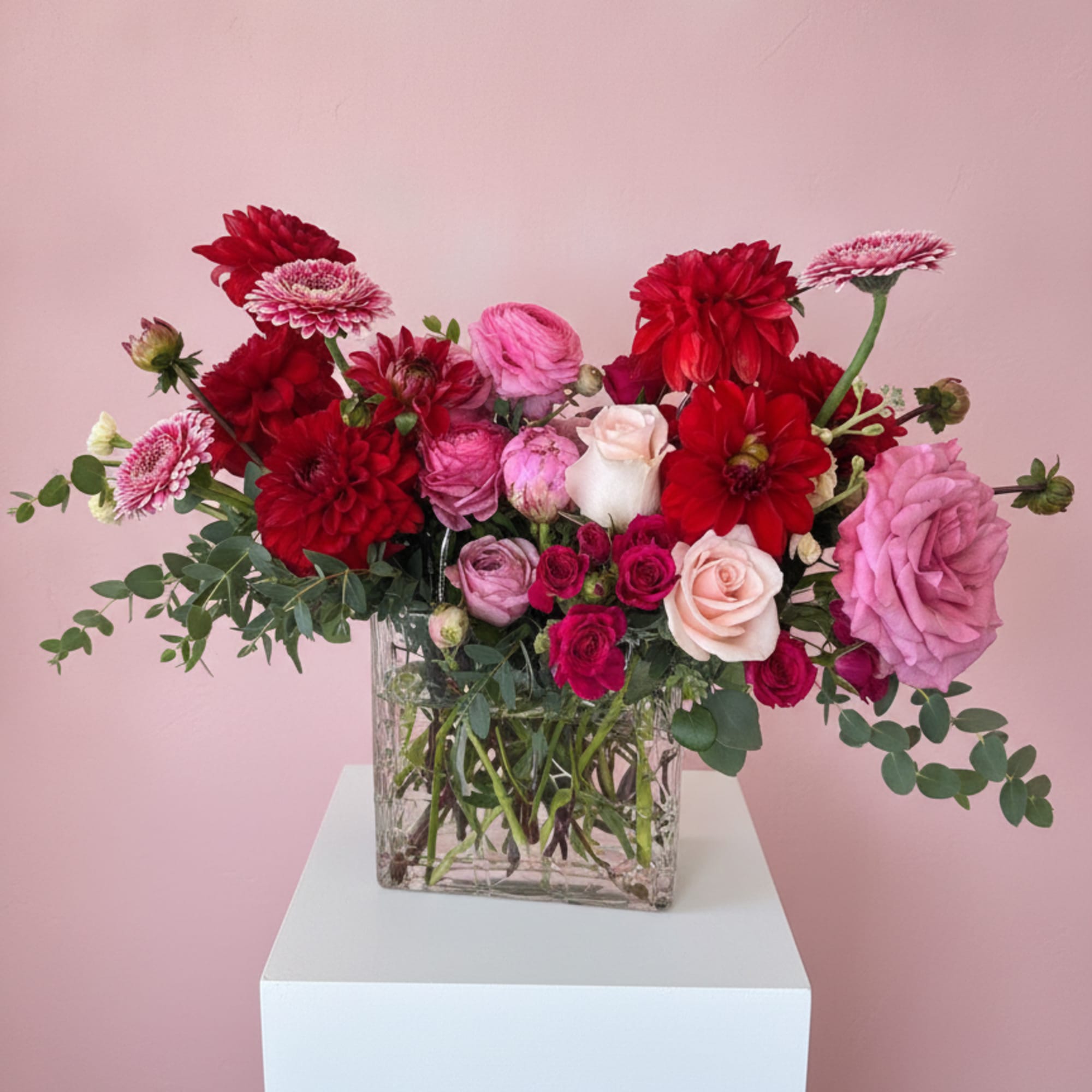 A lush mix of red, pink, and white blooms gathered in a