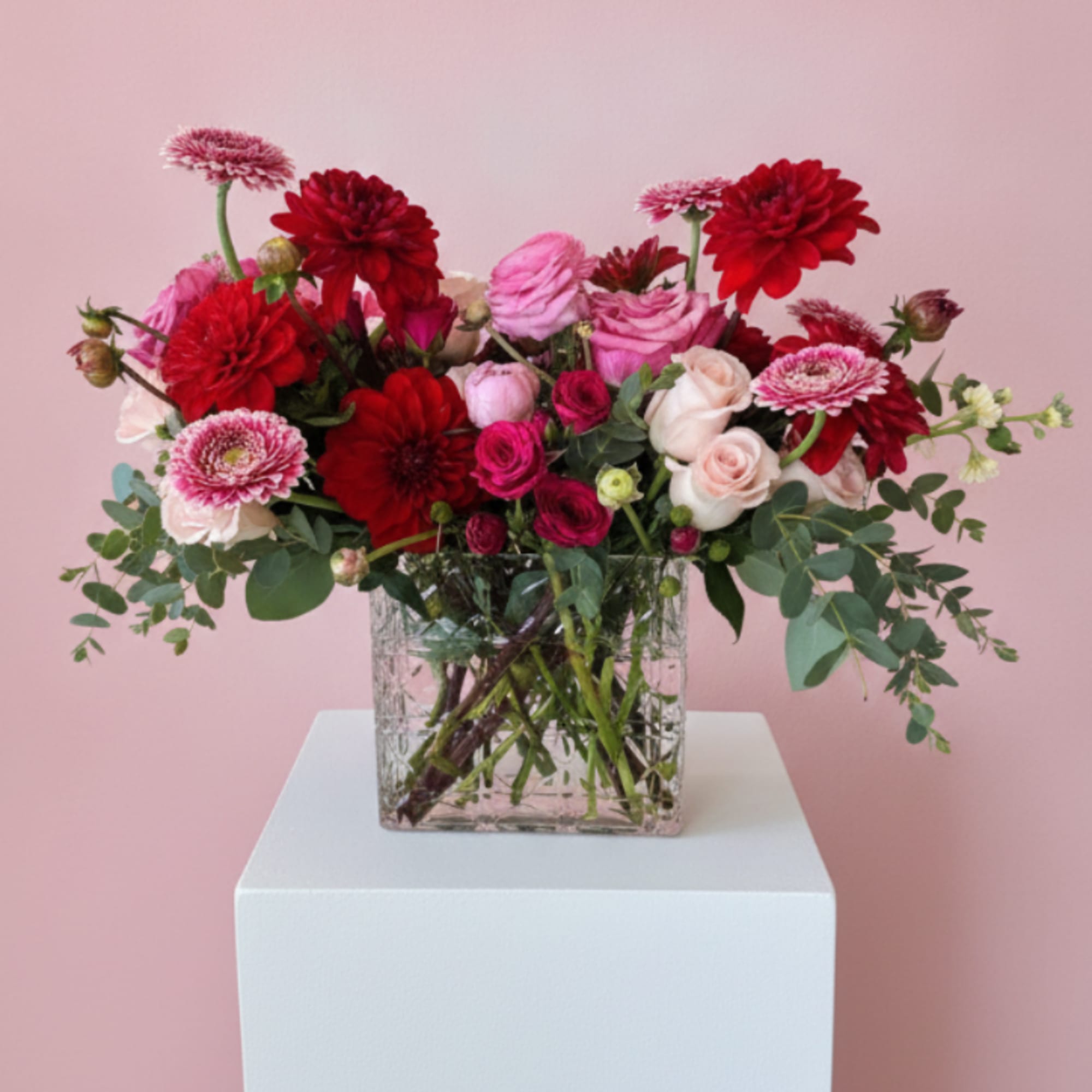 A lush mix of red, pink, and white blooms gathered in a, photo 2 of 2