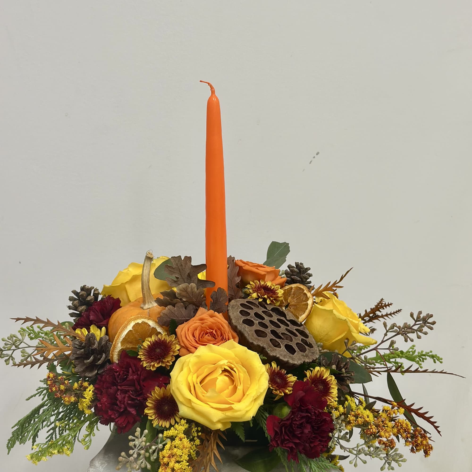Elevate your holiday festivities with the Harvest Glow Centerpiece from Westford Florist