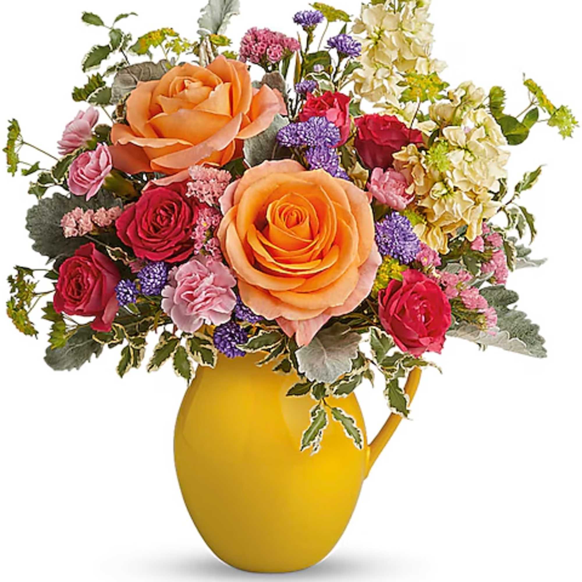 Mixed bouquet of roses and small flowers in a yellow pitcher vase