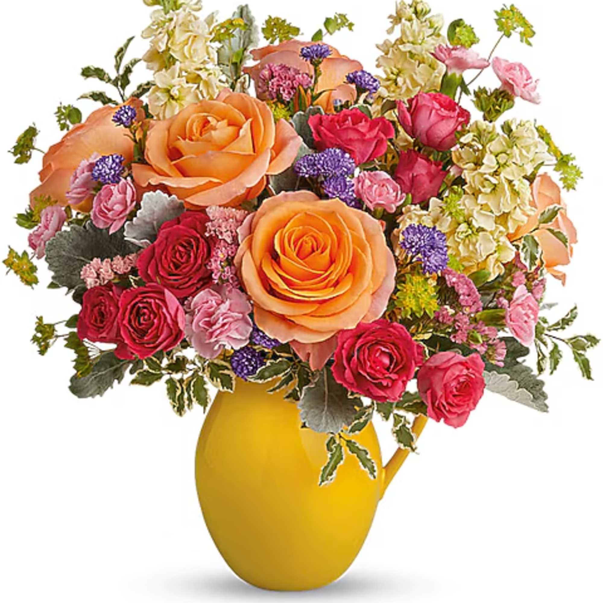 Mixed bouquet of roses and small filler flowers in a yellow vase