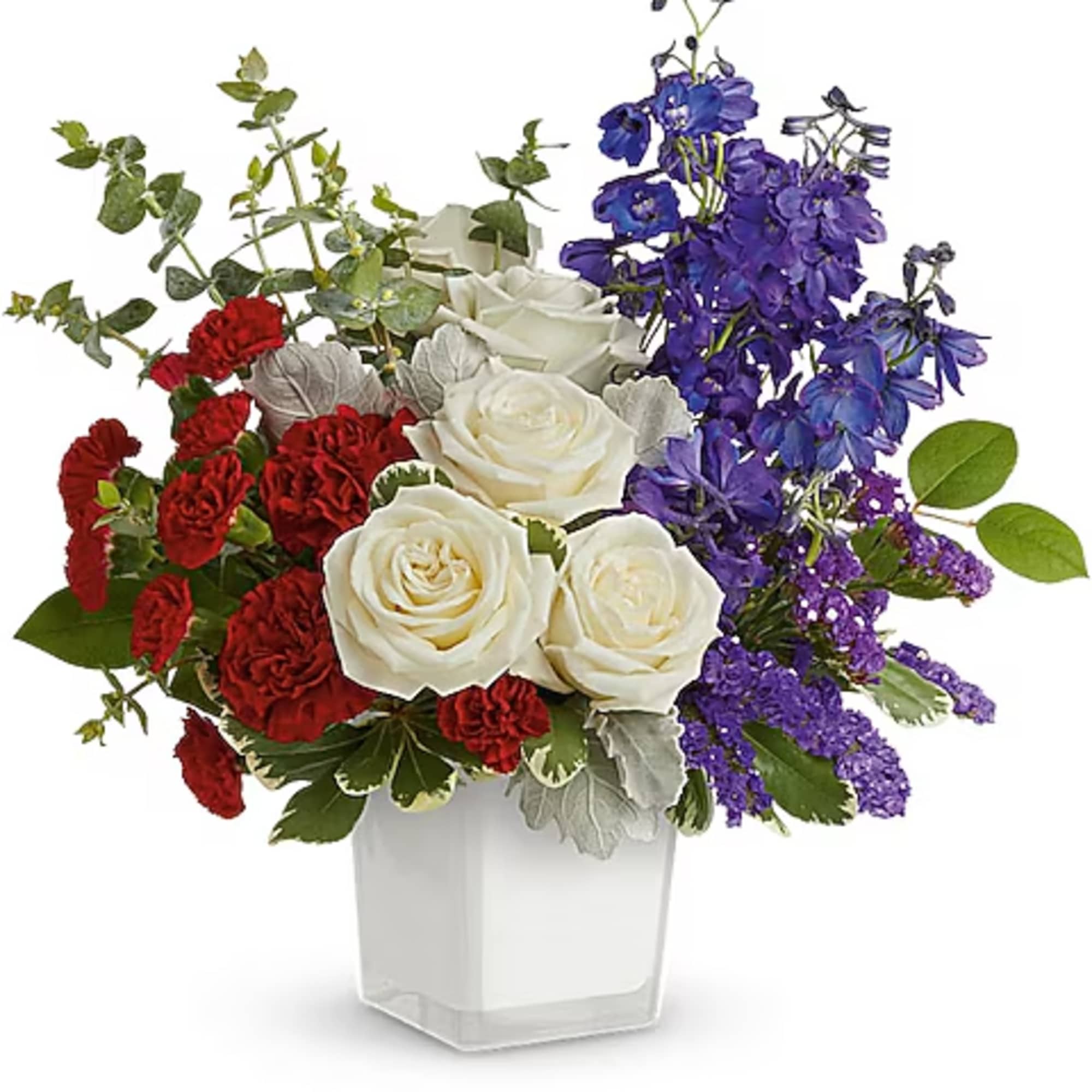 Bouquet of white roses, red carnations, and purple flowers in a clear vase