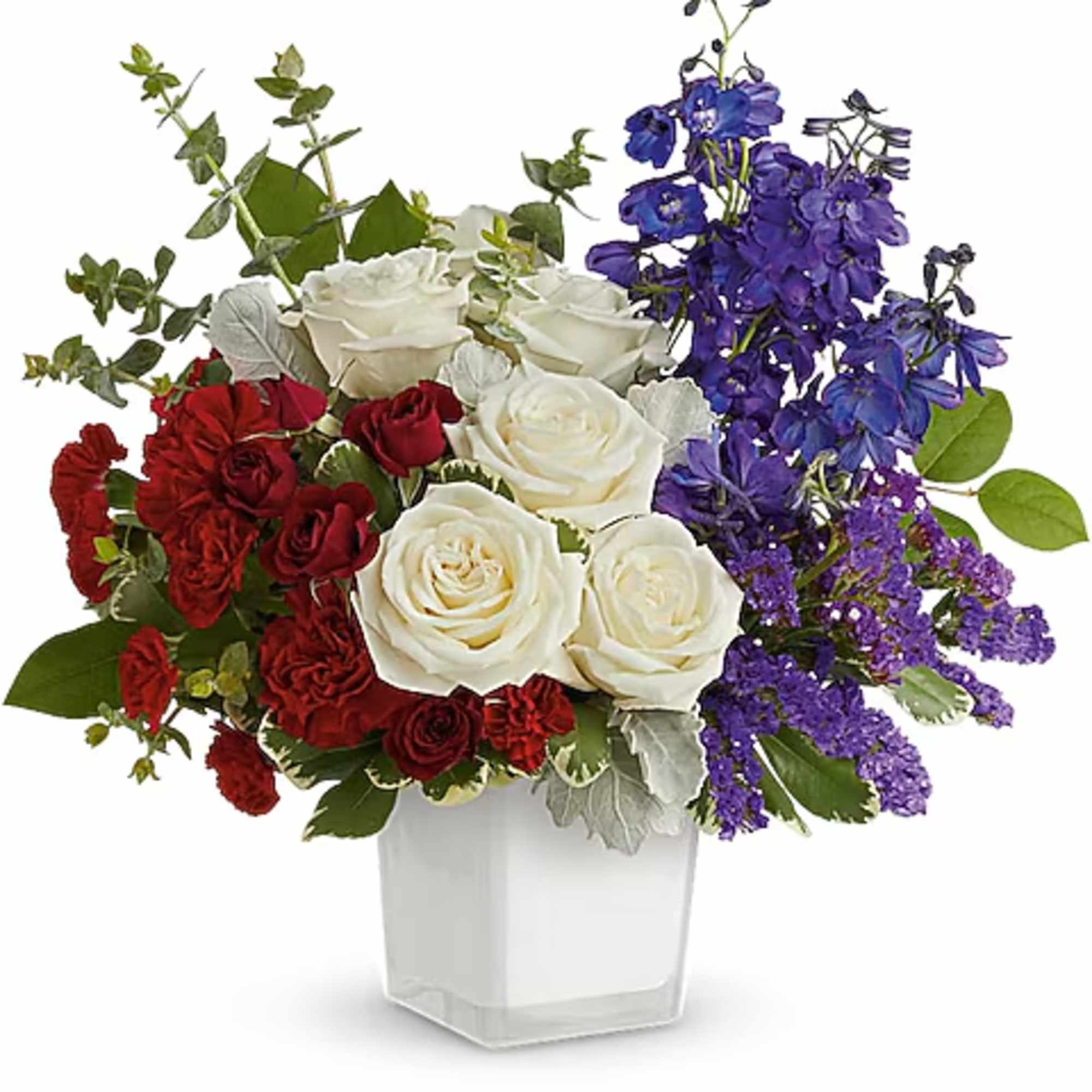 Red, white, and purple rose arrangement in a clear square vase