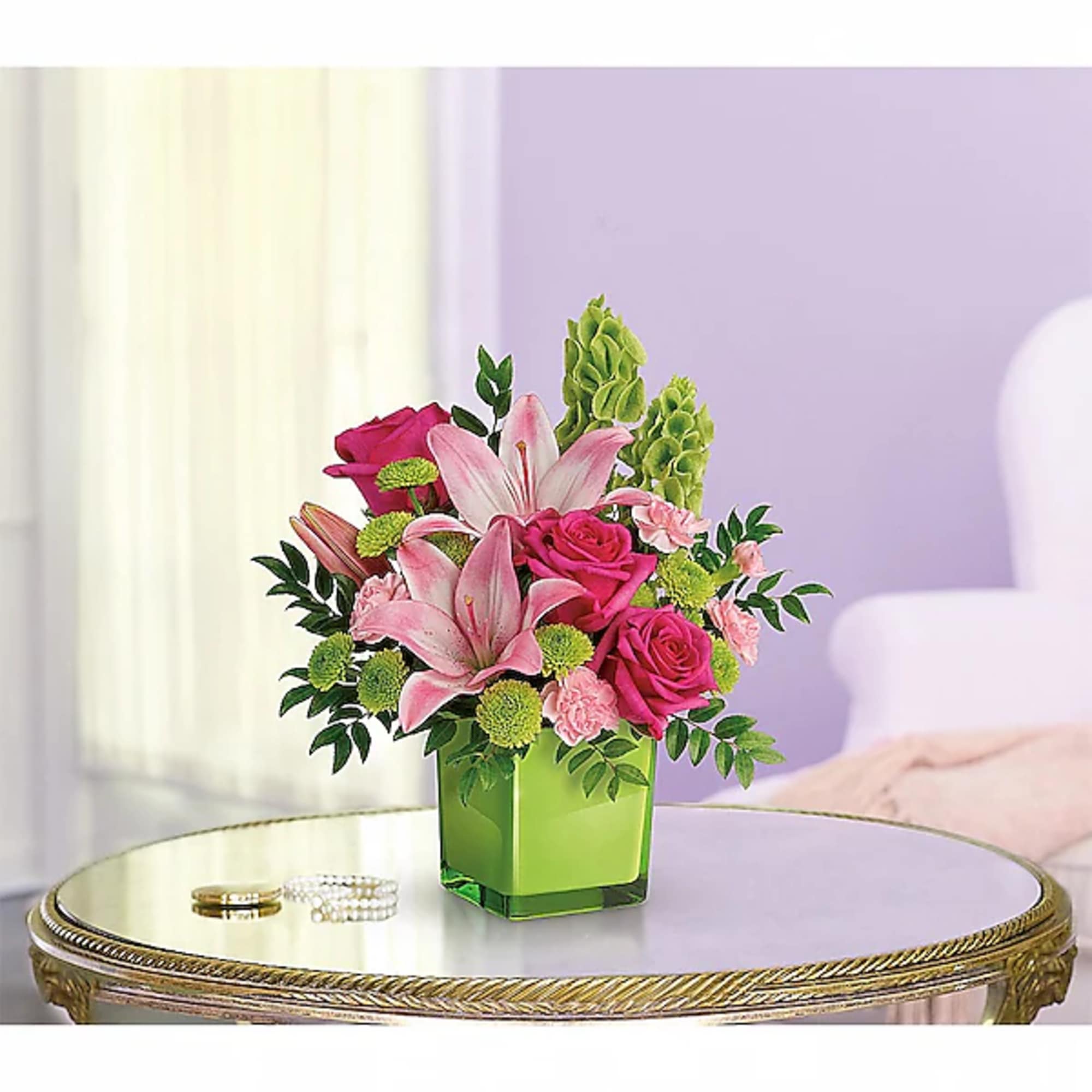Pink lilies and roses in a green square vase