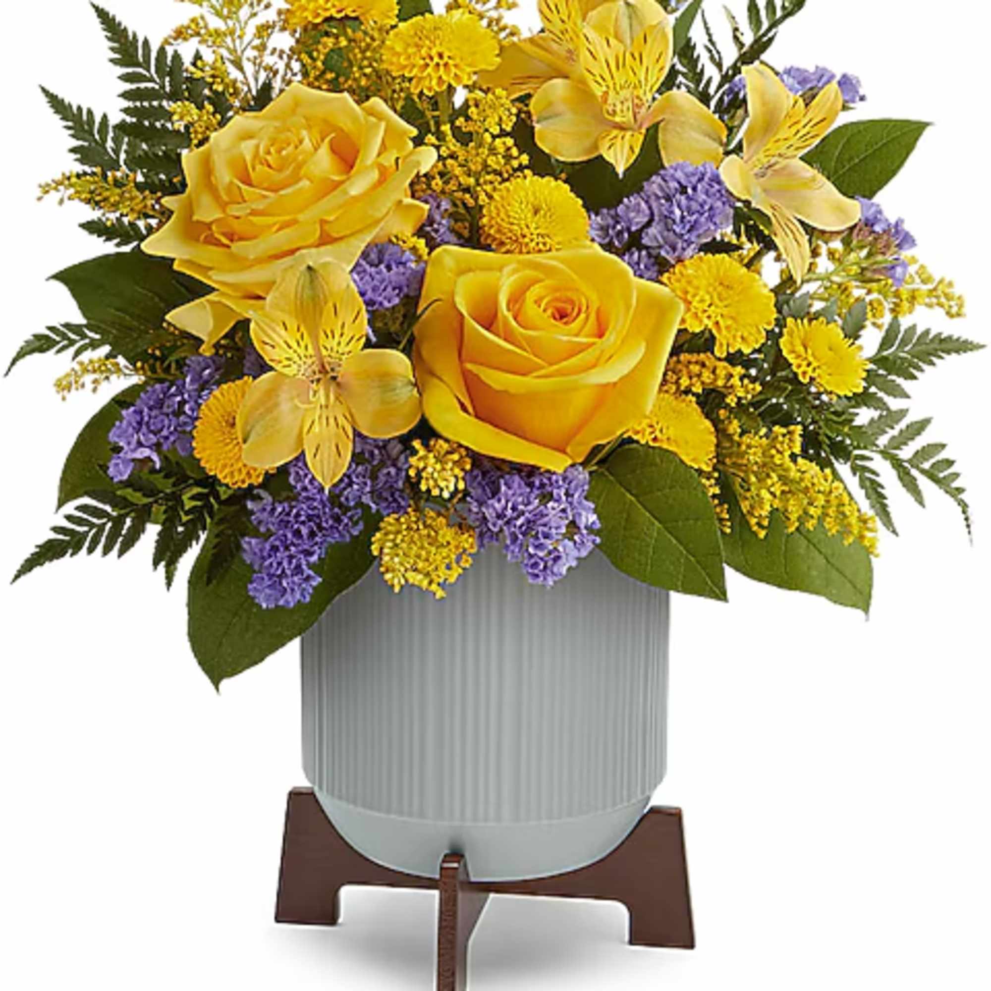 Yellow roses and purple flowers arranged in a vase on a stand