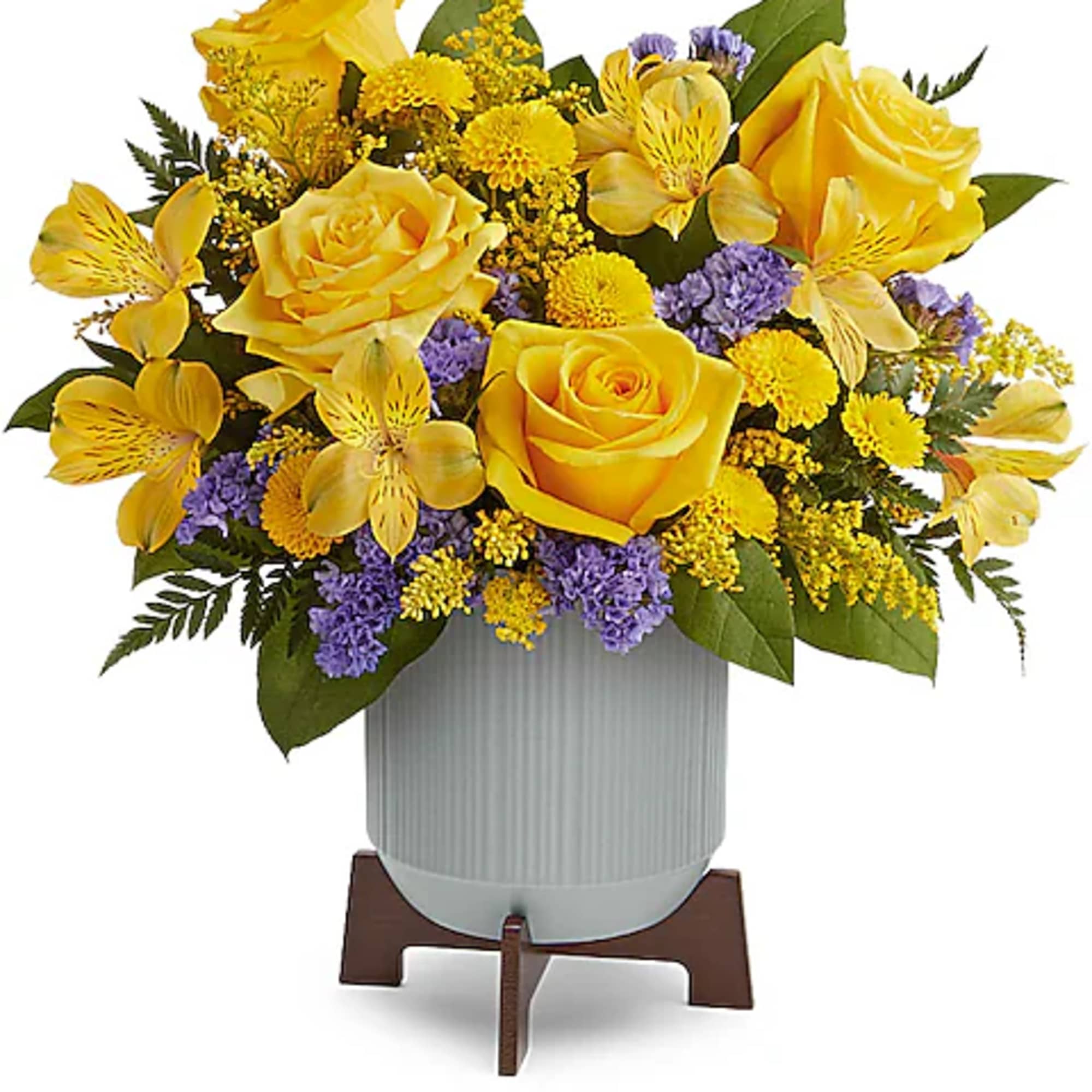Yellow roses and purple flowers arranged in a white vase