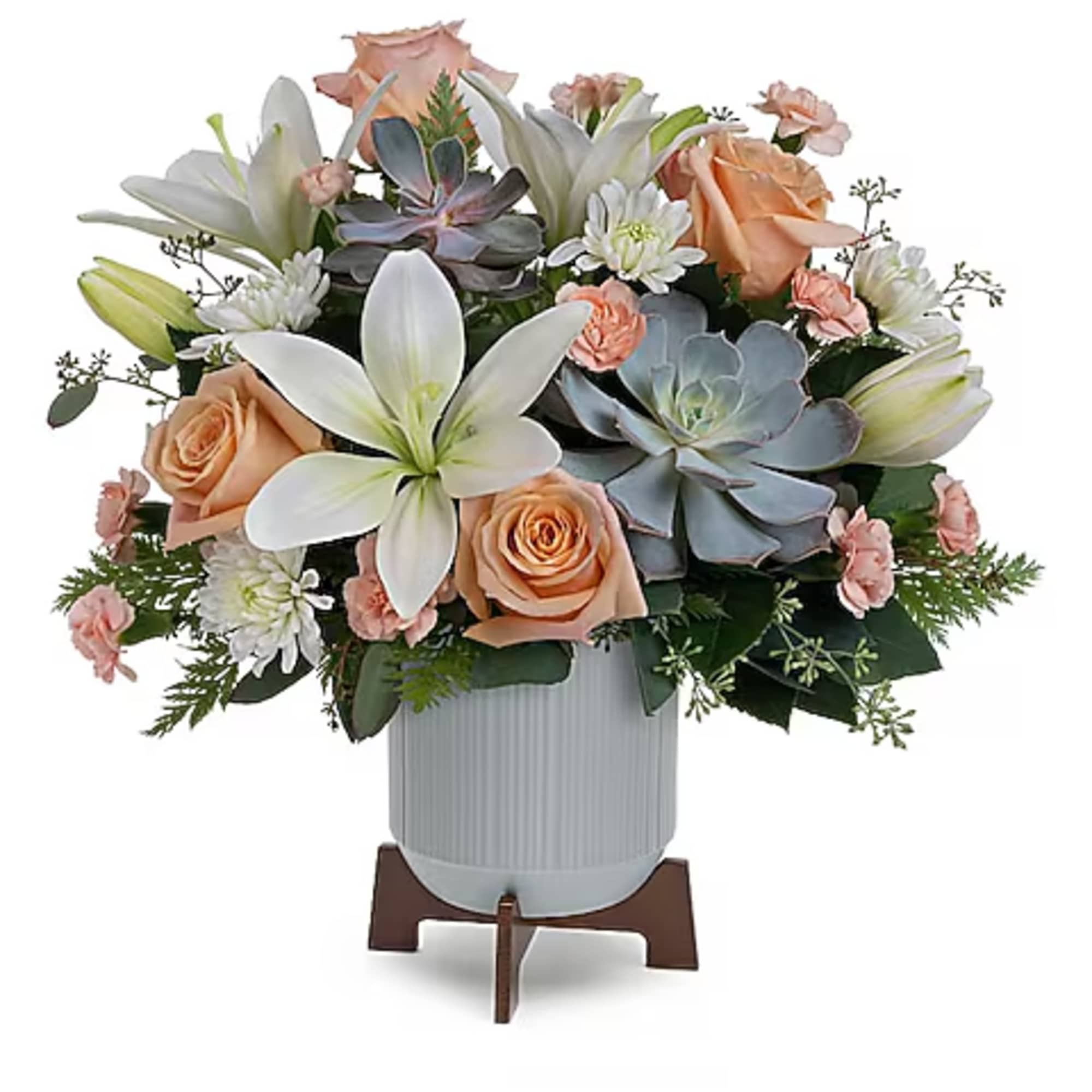 Arrangement of peach roses, white lilies, and succulents in a white vase