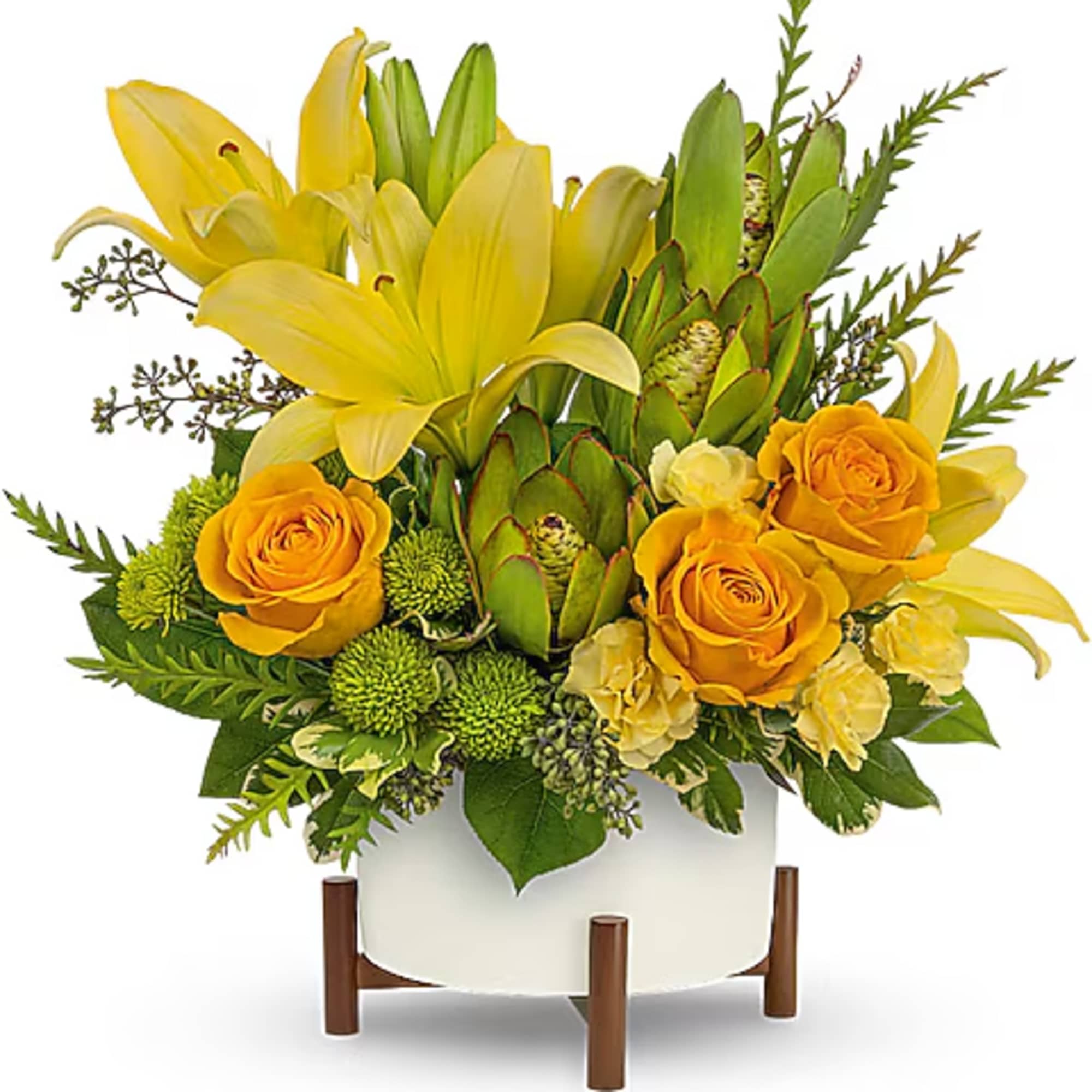 Yellow lilies and roses in a white container with green accents