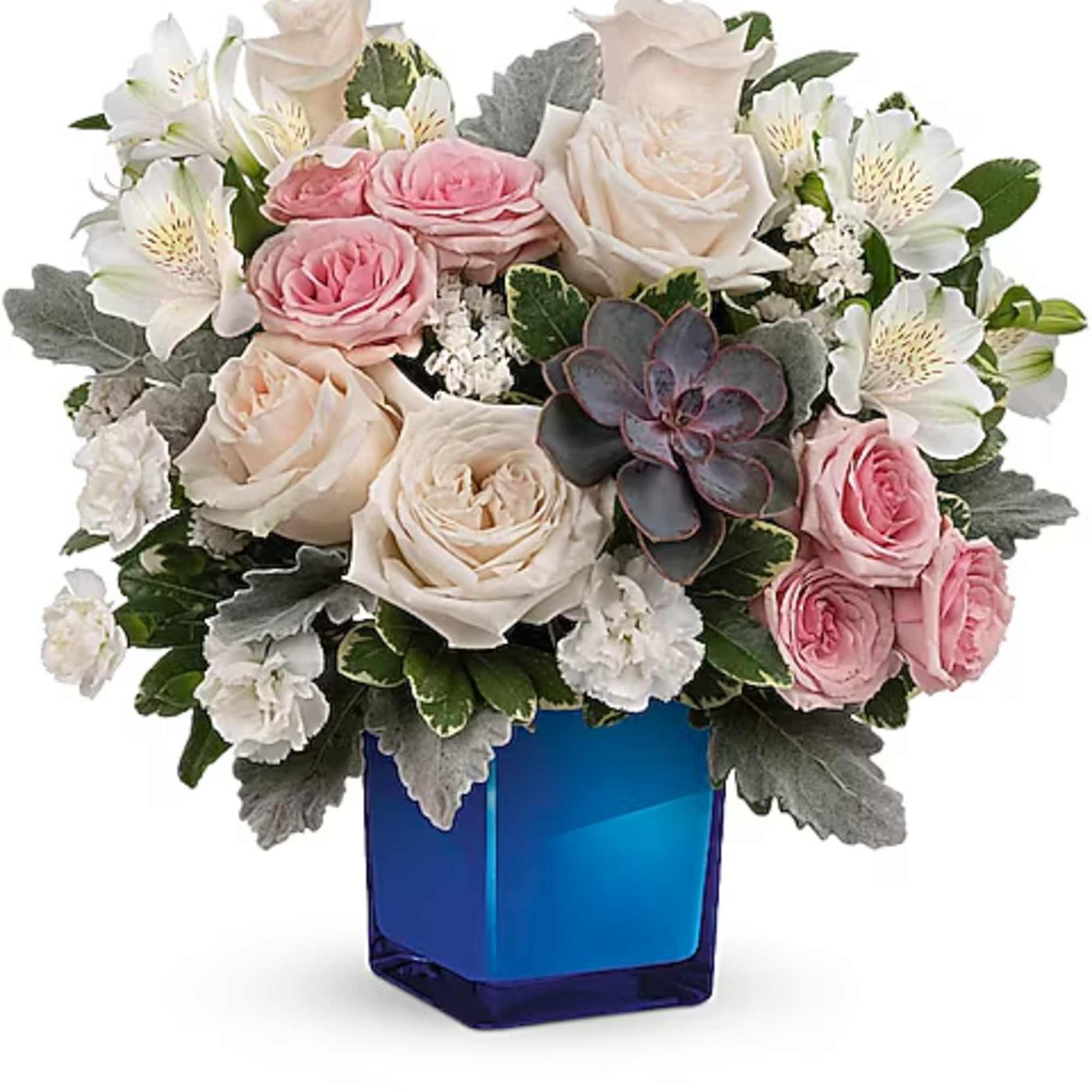 Pink and white roses arranged in a blue glass vase