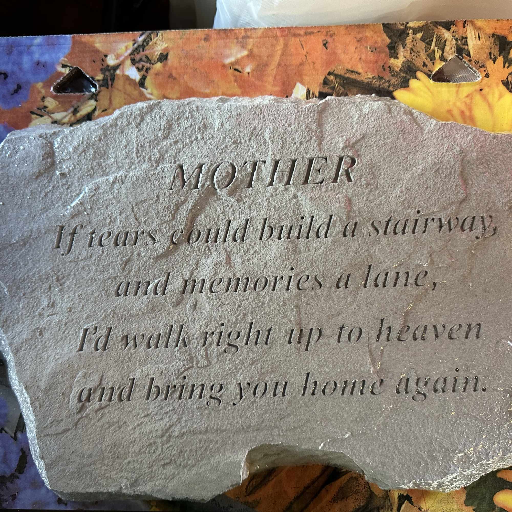 Engraved memorial stone with a mother tribute message