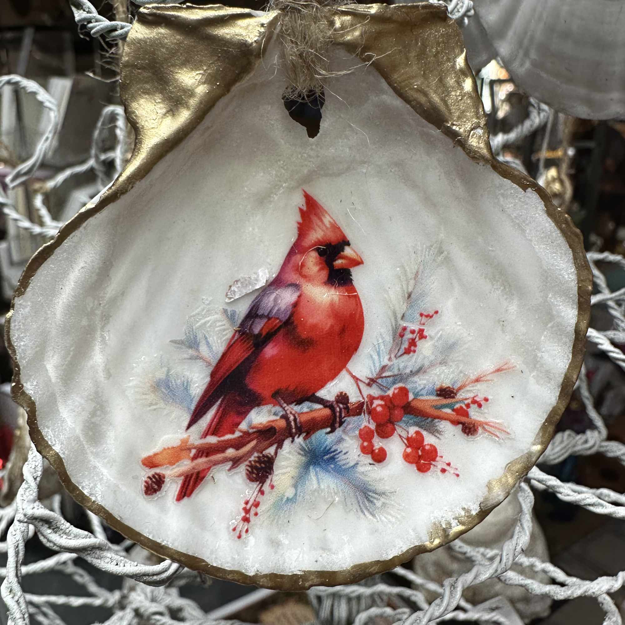 Round ornament with a red cardinal and berry design