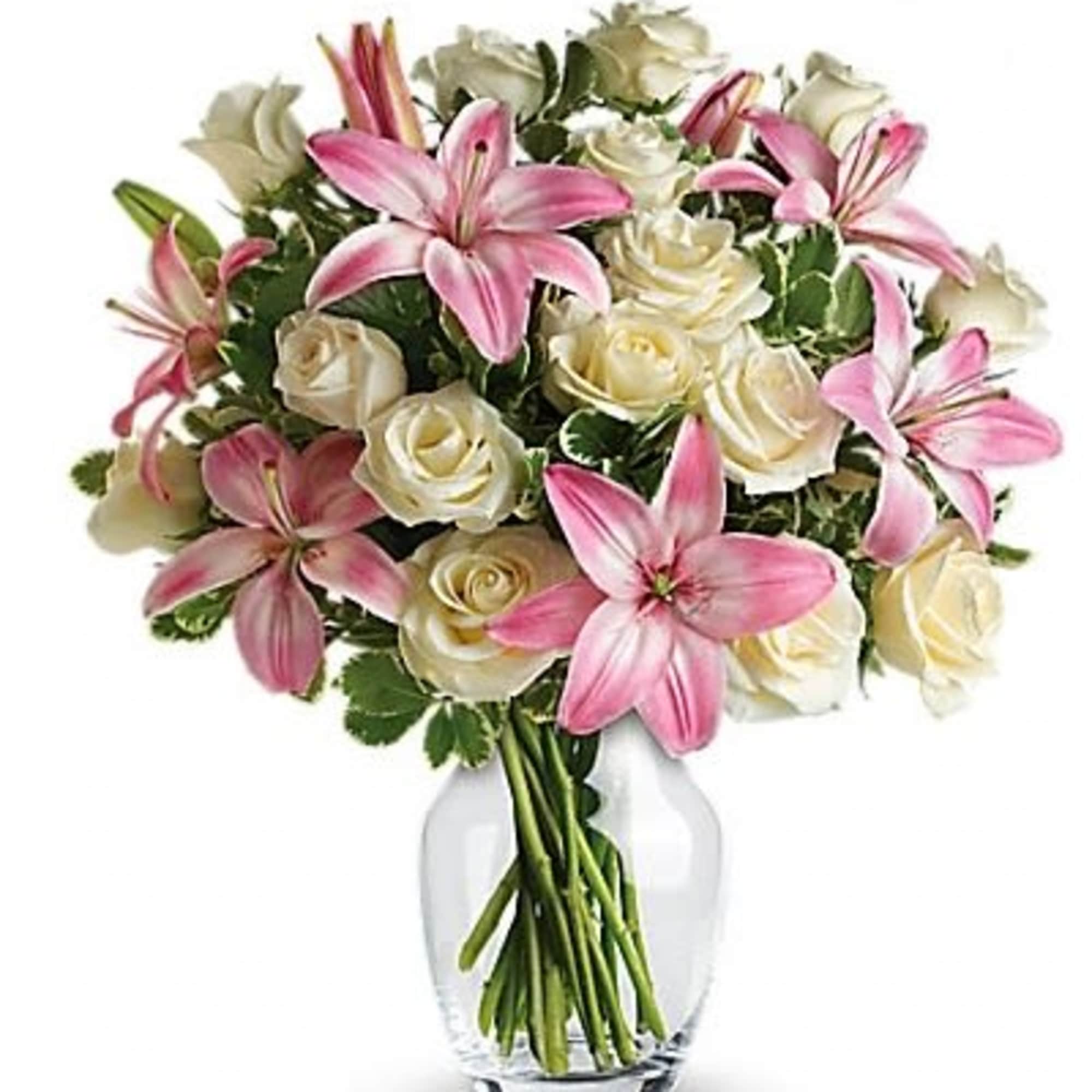 Pink lilies and white roses arranged in a clear glass vase.
