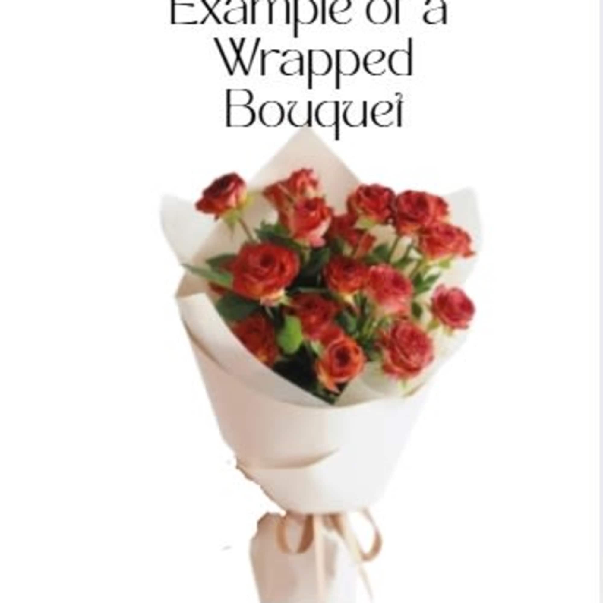 Wrapped bouquet of small red-orange roses in white paper with a ribbon tie