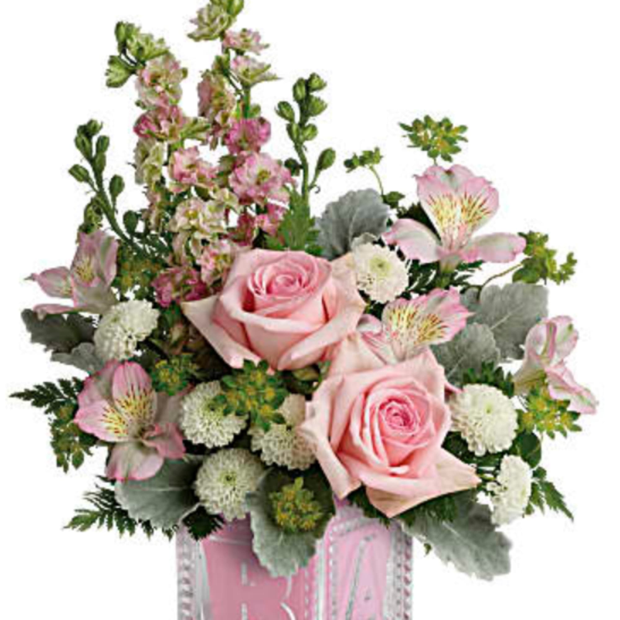 Pink roses and mixed flowers in a clear glass cube vase