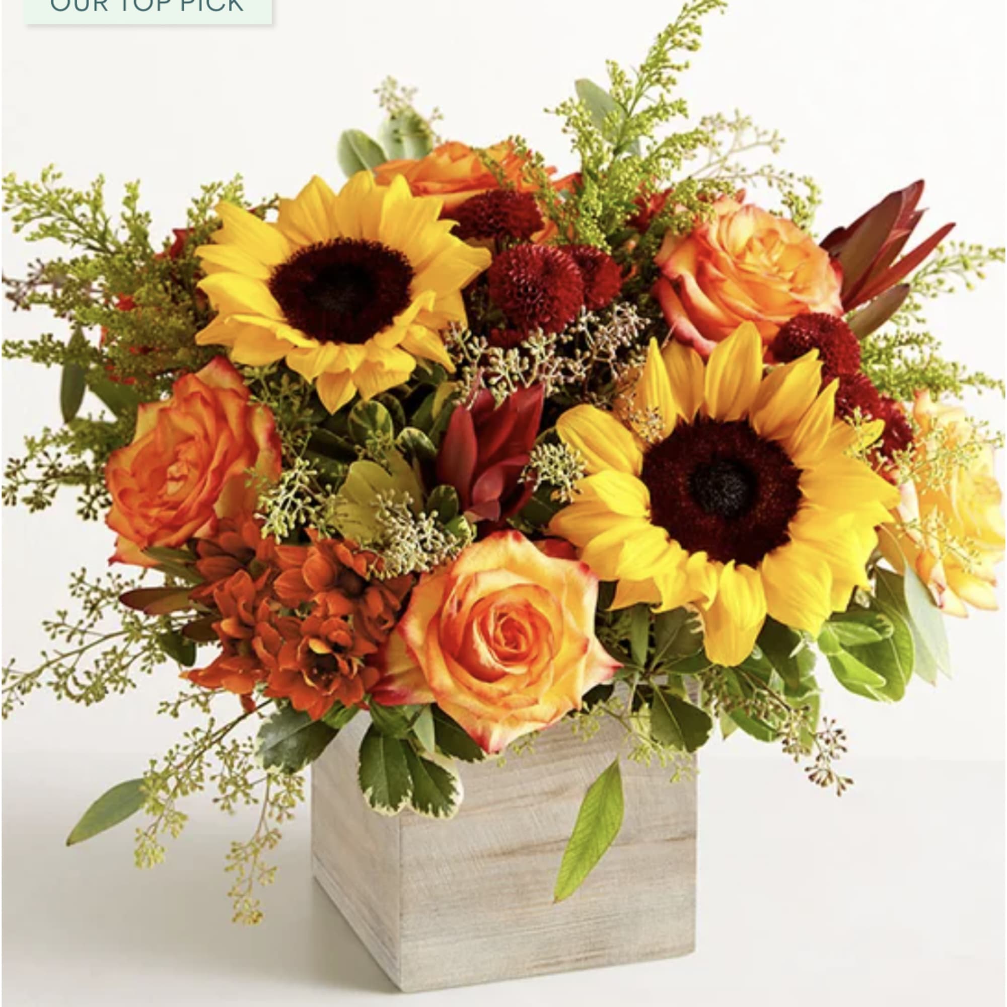 Sunflower and orange rose arrangement in a square wooden vase
