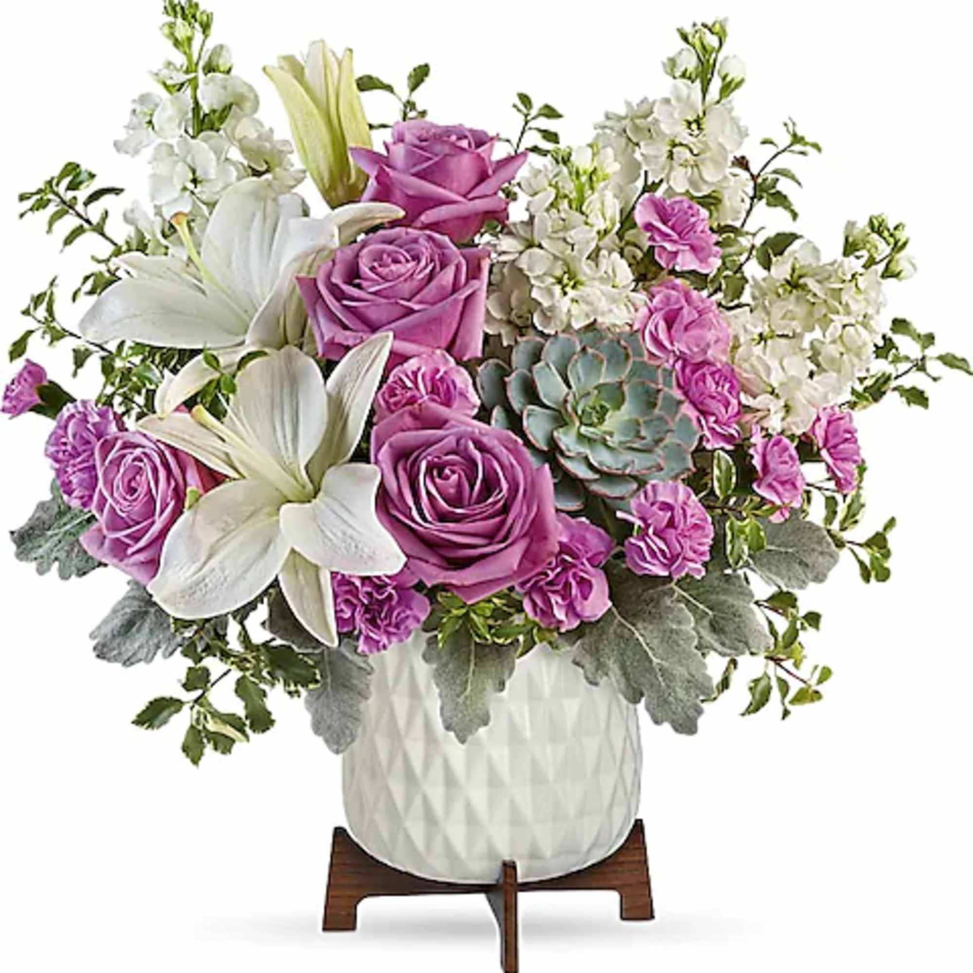 Pink roses and white lilies in a white vase with a succulent accent