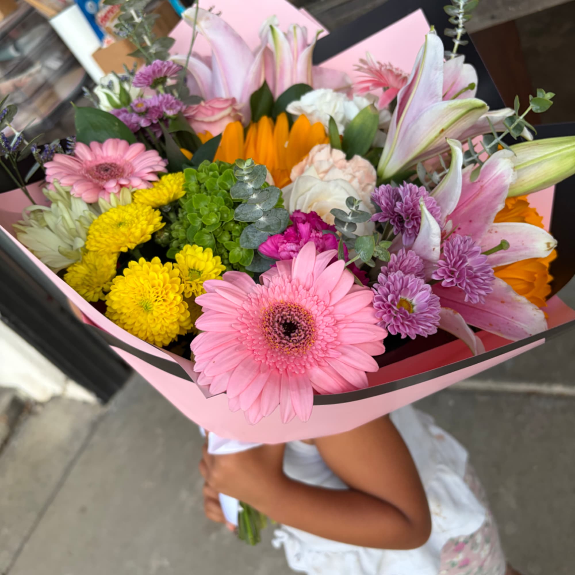 Mixed bouquet with pink lilies, gerbera daisies, and yellow chrysanthemums