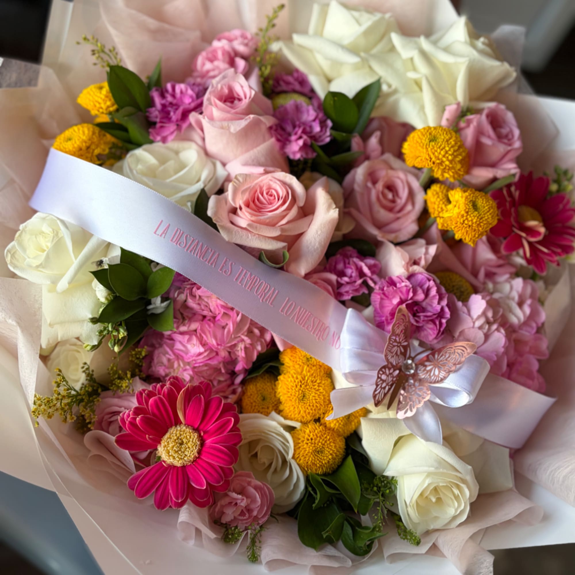 Bouquet of pink and white roses with yellow and magenta flowers