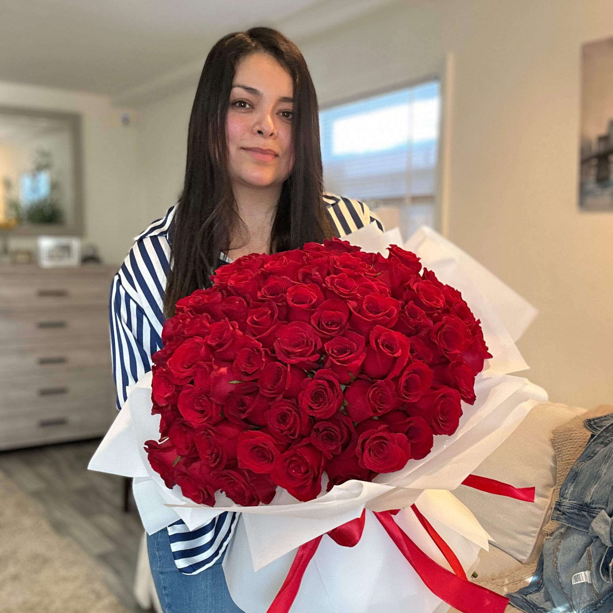 Large bouquet of red roses wrapped in white paper with a red ribbon, photo 5 of 7