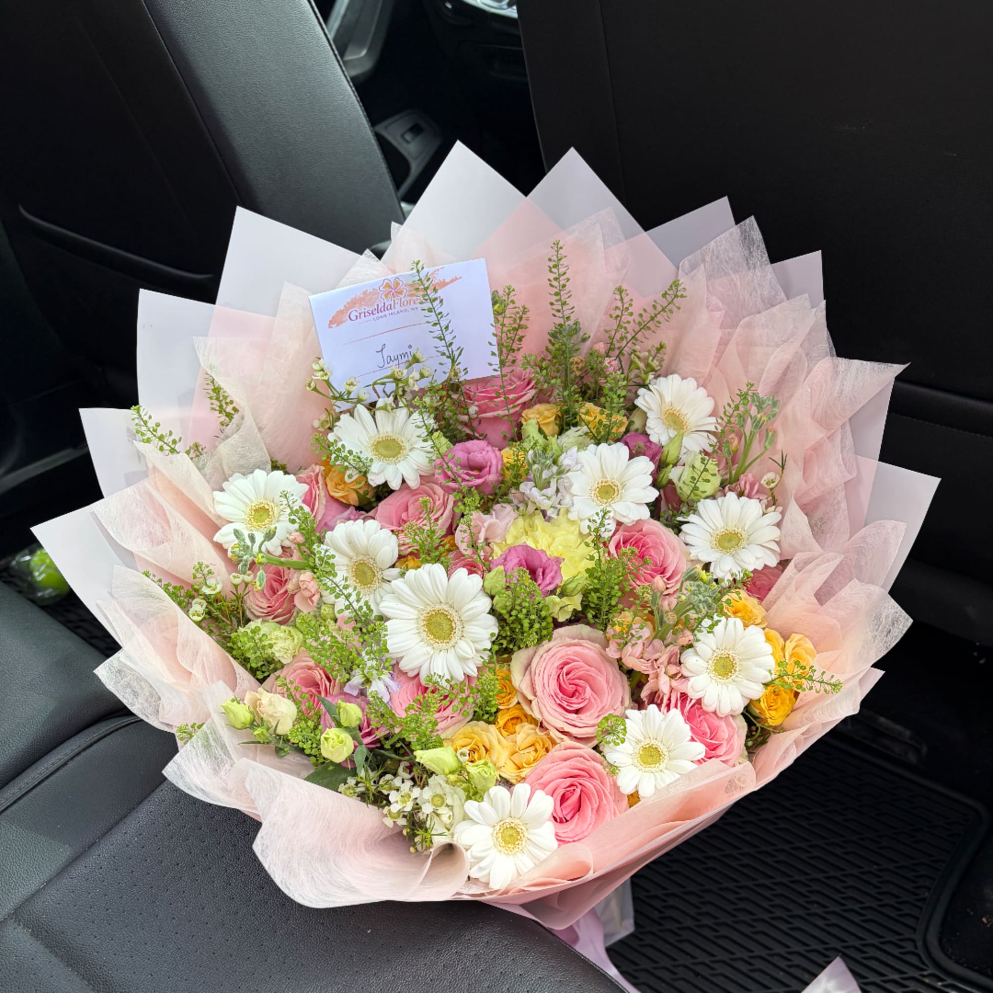 Pink and white mixed bouquet wrapped in pale pink paper