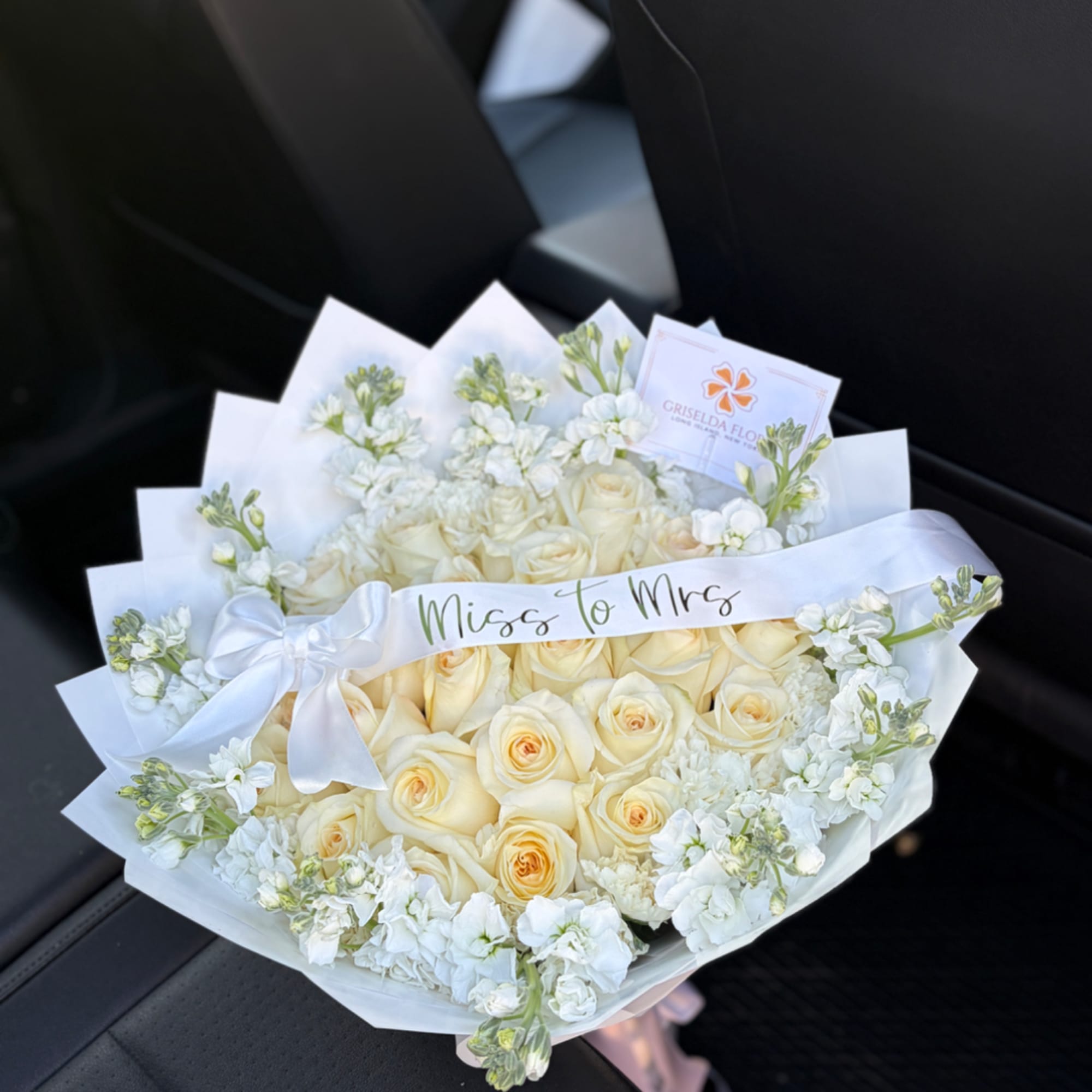 Cream rose bouquet with white ribbon and "Miss to Mrs" sash