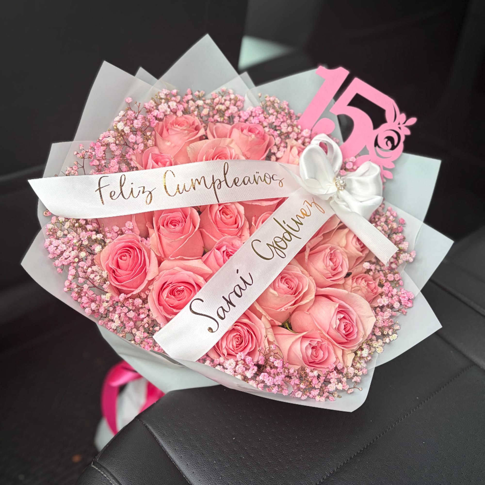 Pink rose bouquet with baby’s breath and a birthday ribbon