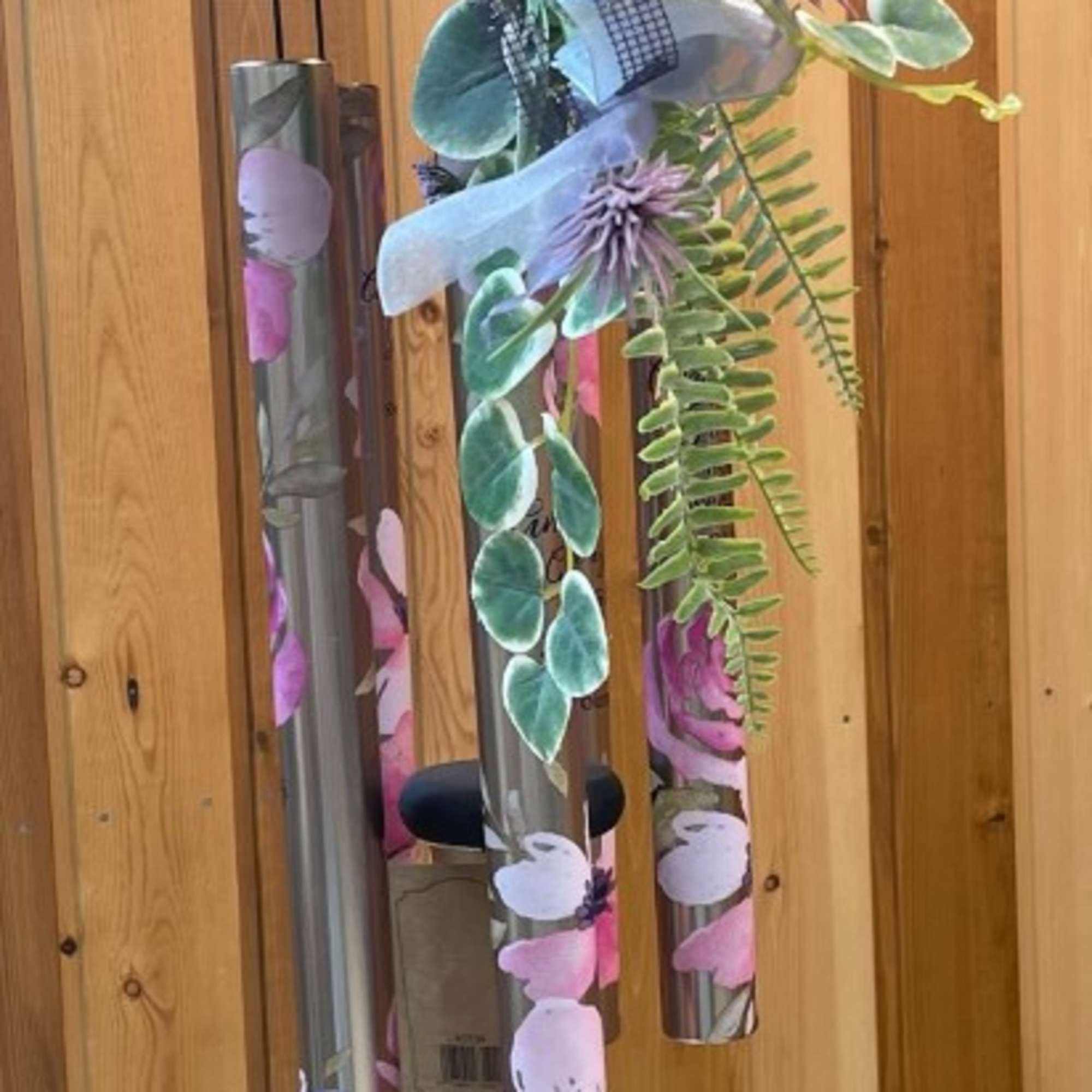 Hanging wind chime with a floral garland and purple accents