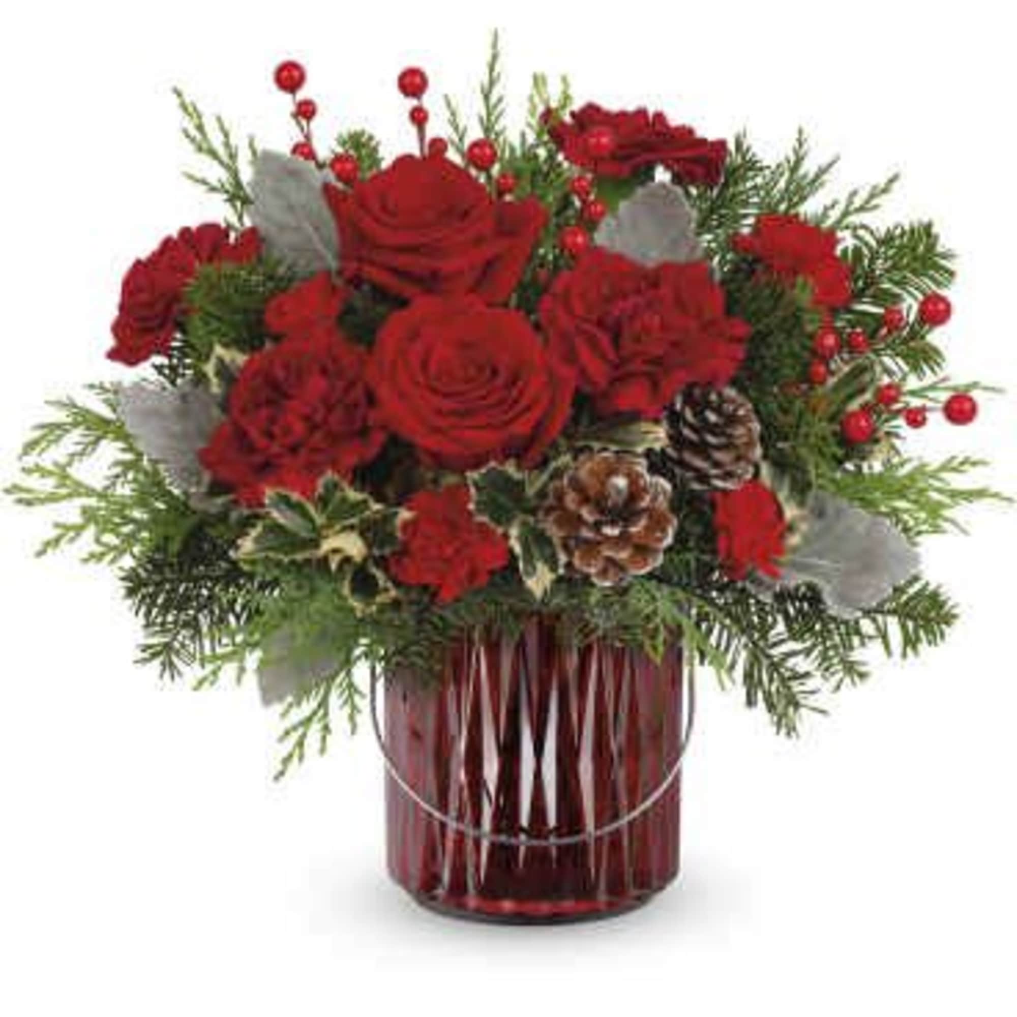 Red roses arranged in a red glass vase with pinecones and evergreen accents
