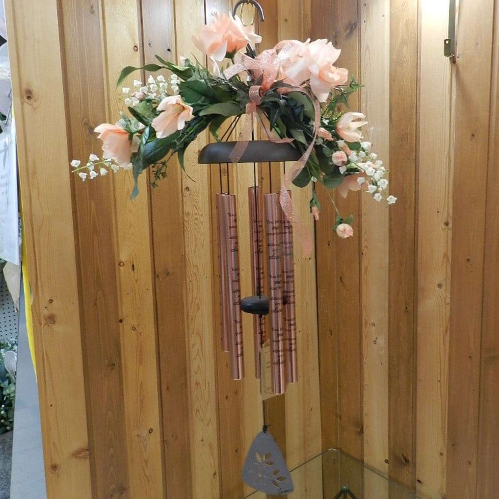 Hanging floral wind chime with pale pink flowers and copper tubes