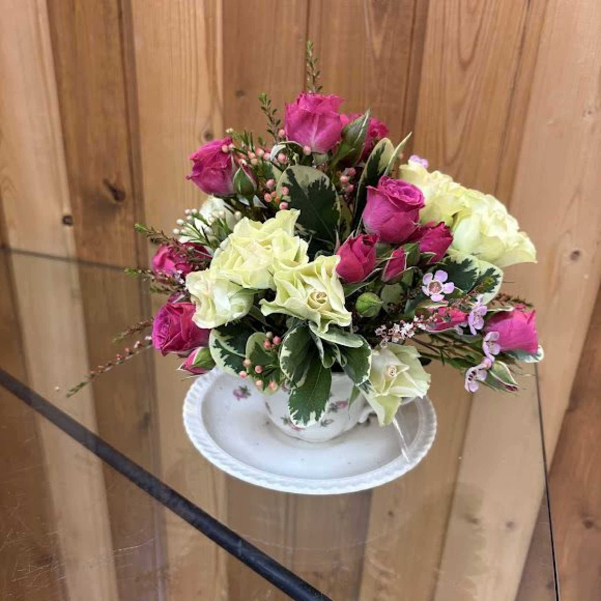 Send this cute little arrangement in a teacup to brighten her day!